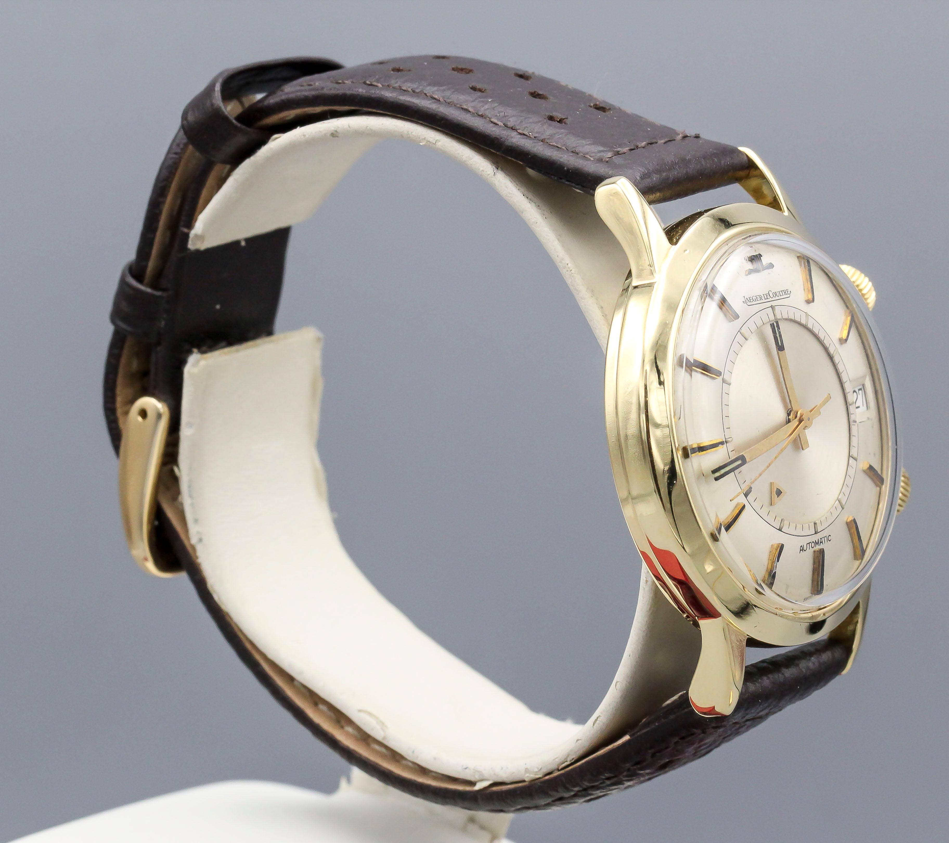 Fine 18K yellow gold Jaeger LeCoultre Memovox wristwatch. It features an automatic movement and an alarm function. It is more rare than the gold filled counterparts, because of the enamel hour markers, it's a solid 18K gold case, it features a date