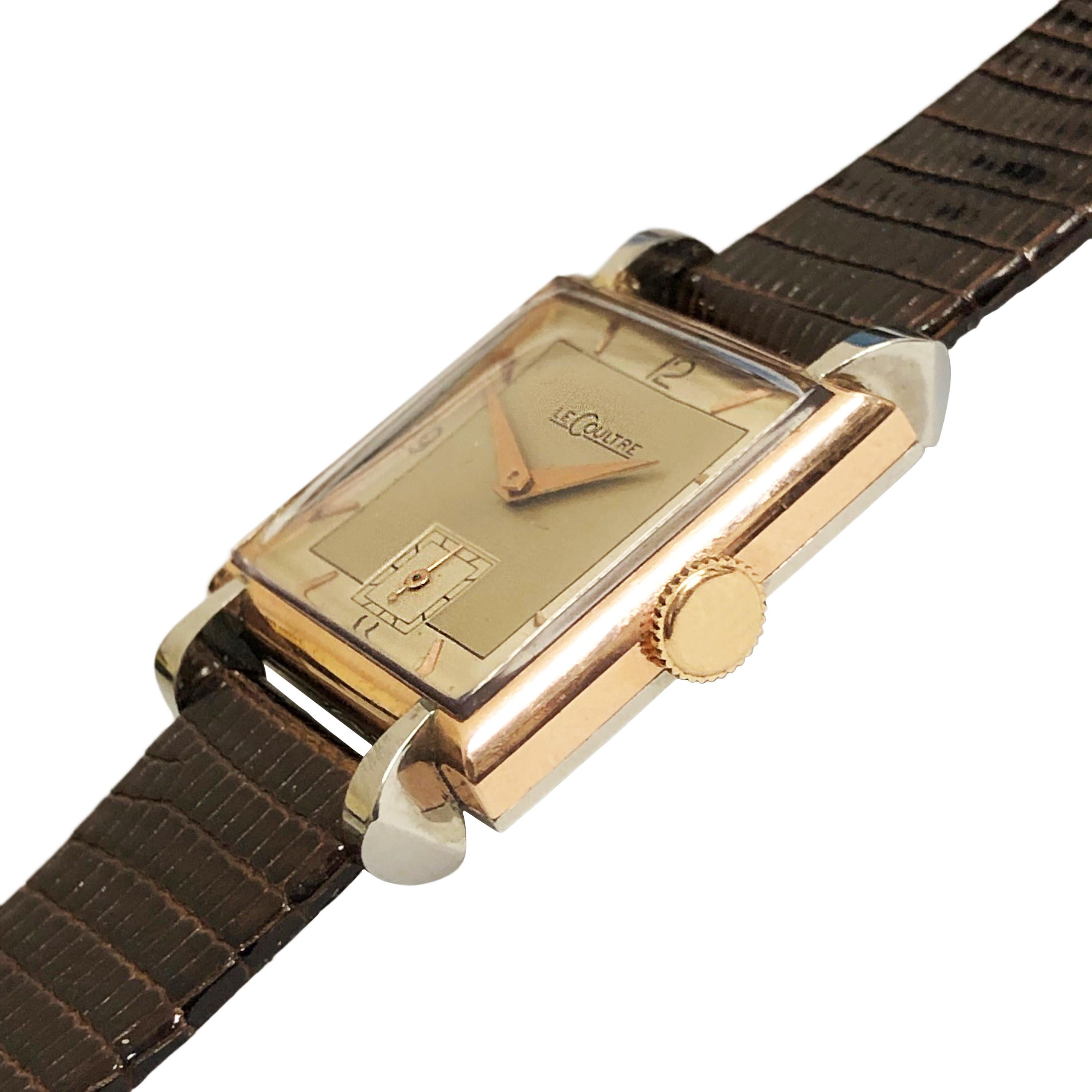 Circa 1940s Jaeger LeCoultre Wrist Watch, 34 X 25 MM 2 Piece Stainless Steel and Rose Gold Case with Flared Lugs. 17 Jewel Mechanical, Manual wind movement, original 2 tone silvered dial with raised Rose Gold markers and Rose Gold hands. New Brown