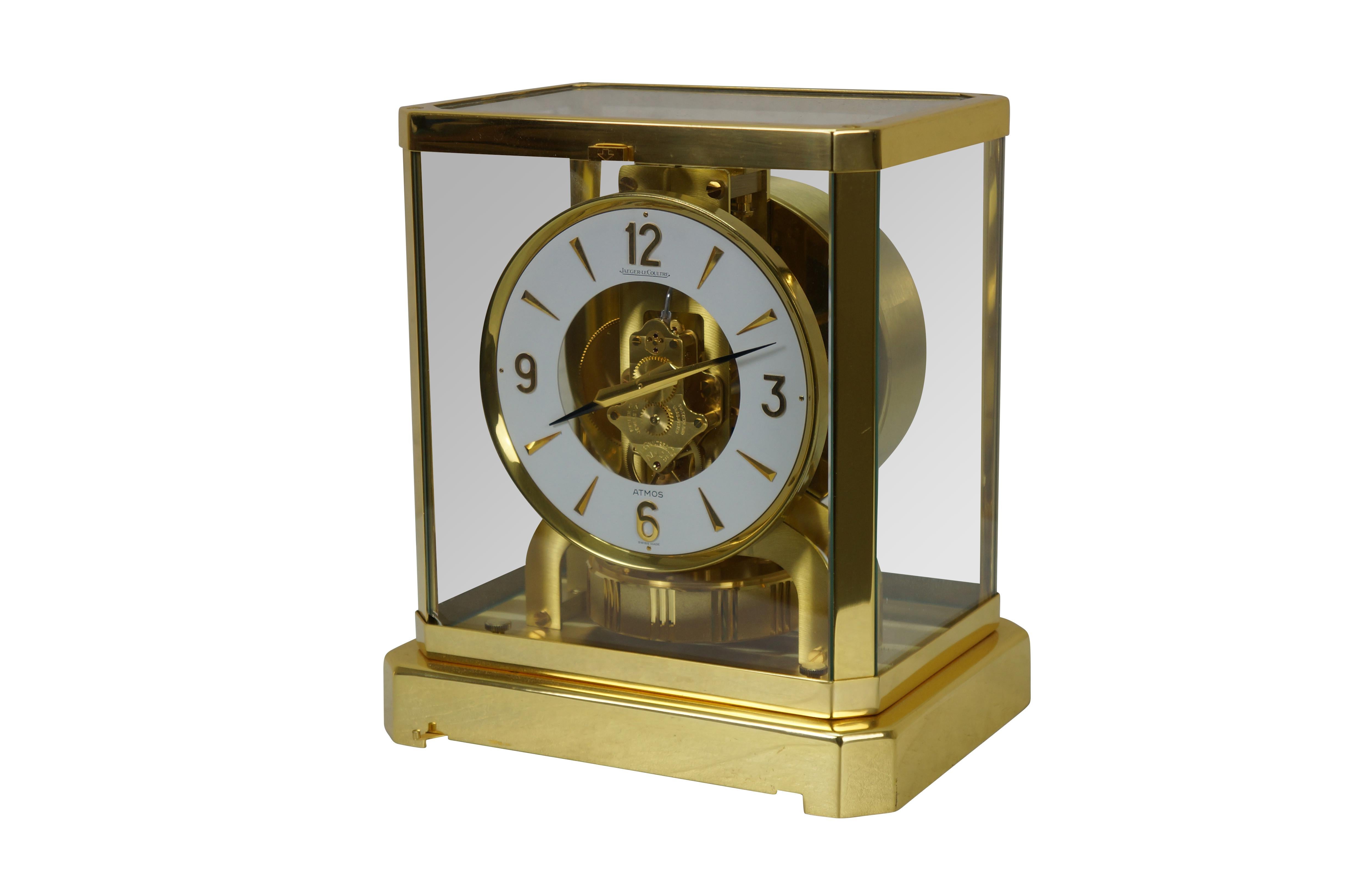 Circa 1960s Jaeger-Le Coultre Atmos perpetual motion mantel clock. Bright polished brass frame with glass sides. White face with gold tone Arabic numerals, pips and hands. Le Coultre & Cie - Metal - Caliber 528-8 - Swiss - C. Falt & Co. Serial