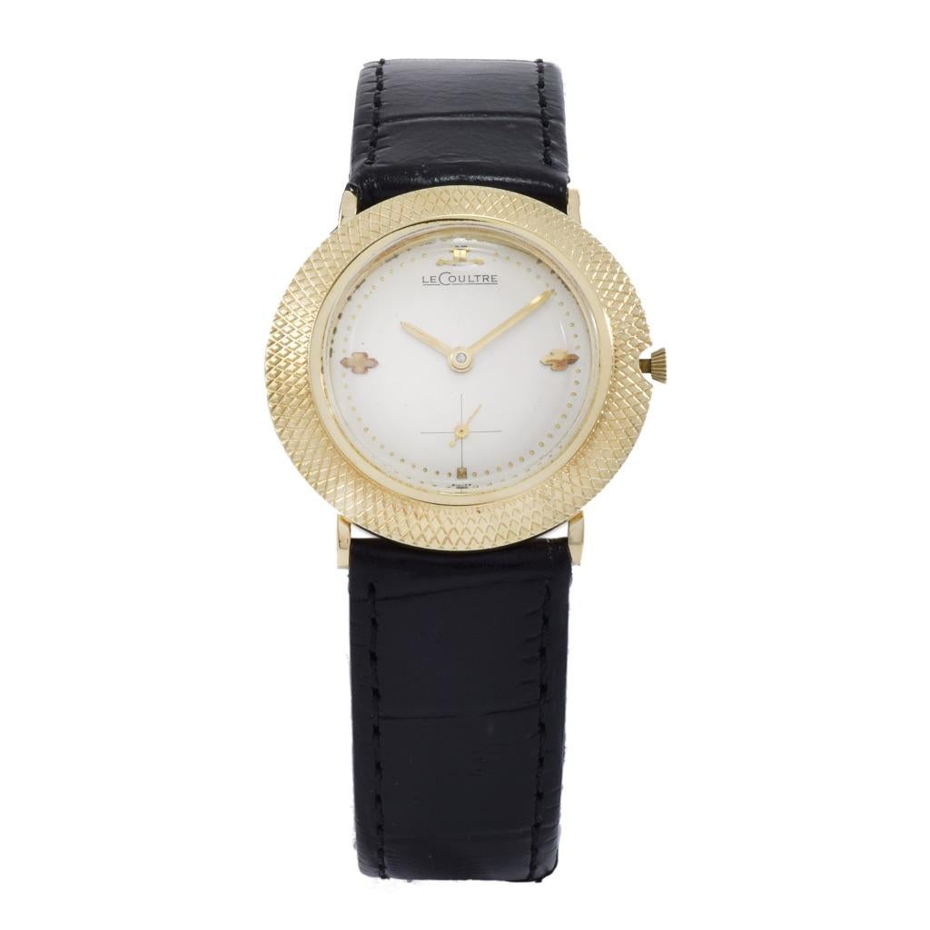Introducing the LeCoultre vintage 1950's wristwatch, a timeless embodiment of elegance. This exquisite timepiece features a 32mm round 14kt yellow gold case, a beige dial, gold markers and hands, sub dial second hand, and a mechanical manual wind