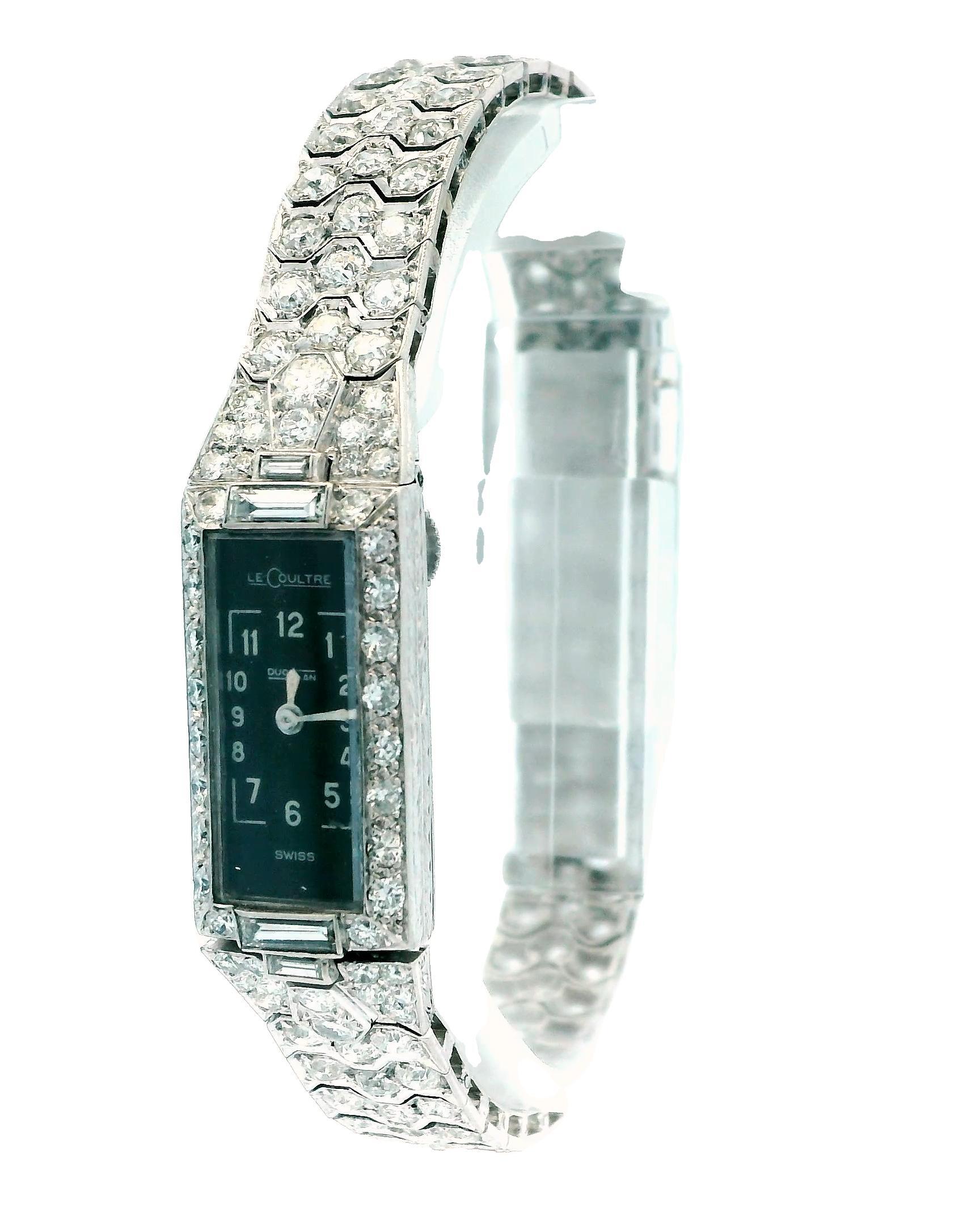Orologio Jaeger-LeCoultre in platino e diamanti rettangolare 11,8MM By26MM. Movimento manuale. Quadrante nero con numeri arabi. Lunetta con diamante. Fondello solido. Gruppo di metallo misto. Peso totale dei diamanti 7,0, taglio brillante, colore F,