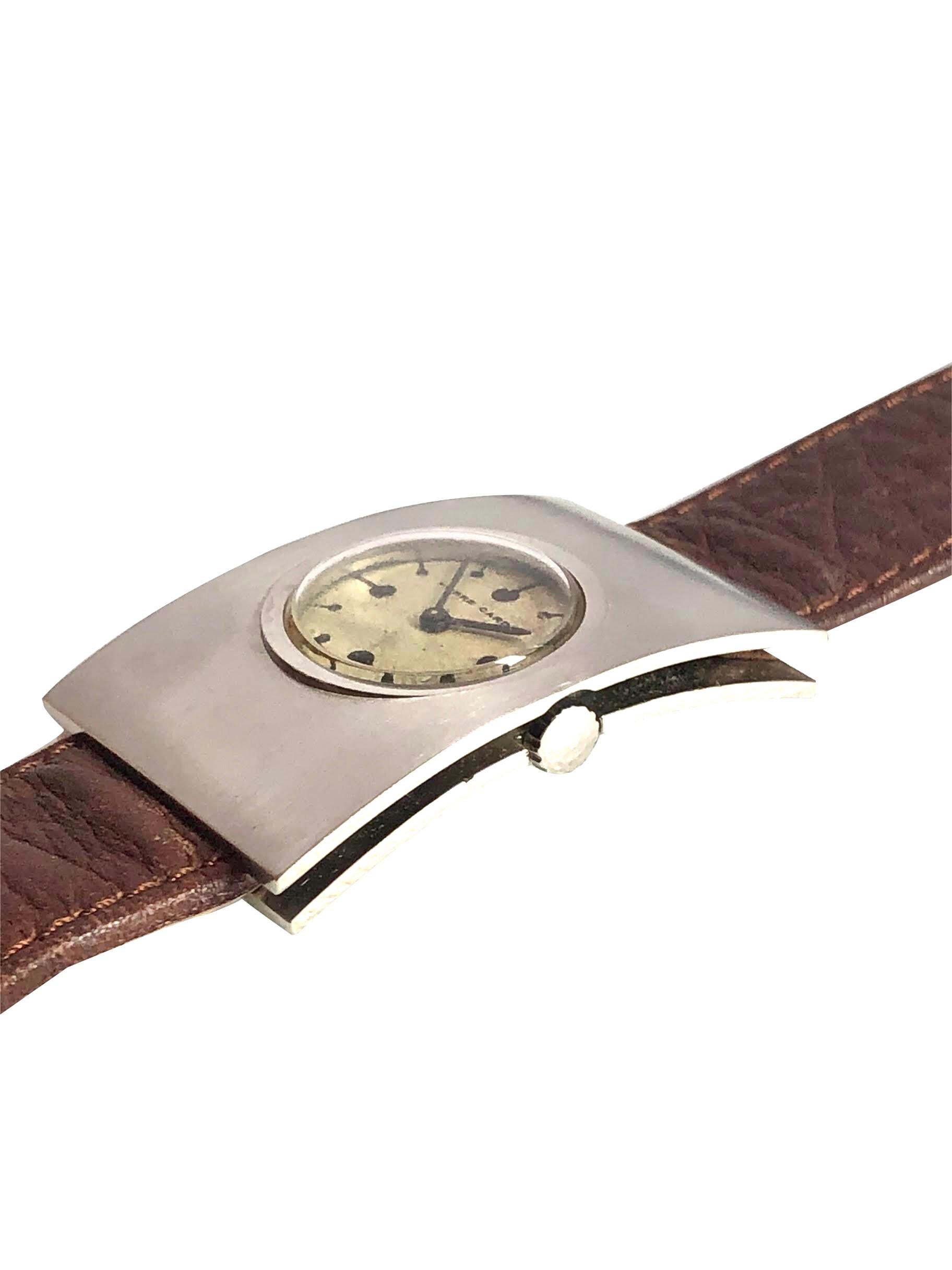 Circa 1970s Mid Century Wrist Watch for Pierre Cardin, 47 X 30 M.M. Stainless Steel 3 piece case. Jaeger LeCoultre 17 Jewel Mechanical, Manual Wind movement, original silver satin dial. Newer Brown Leather strap with original Steel Buckle. Watch