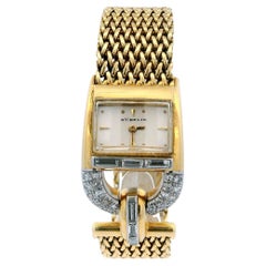 Gubelin Reloj de mujer con pulsera de estribo de oro amarillo de 18 quilates con pavé
