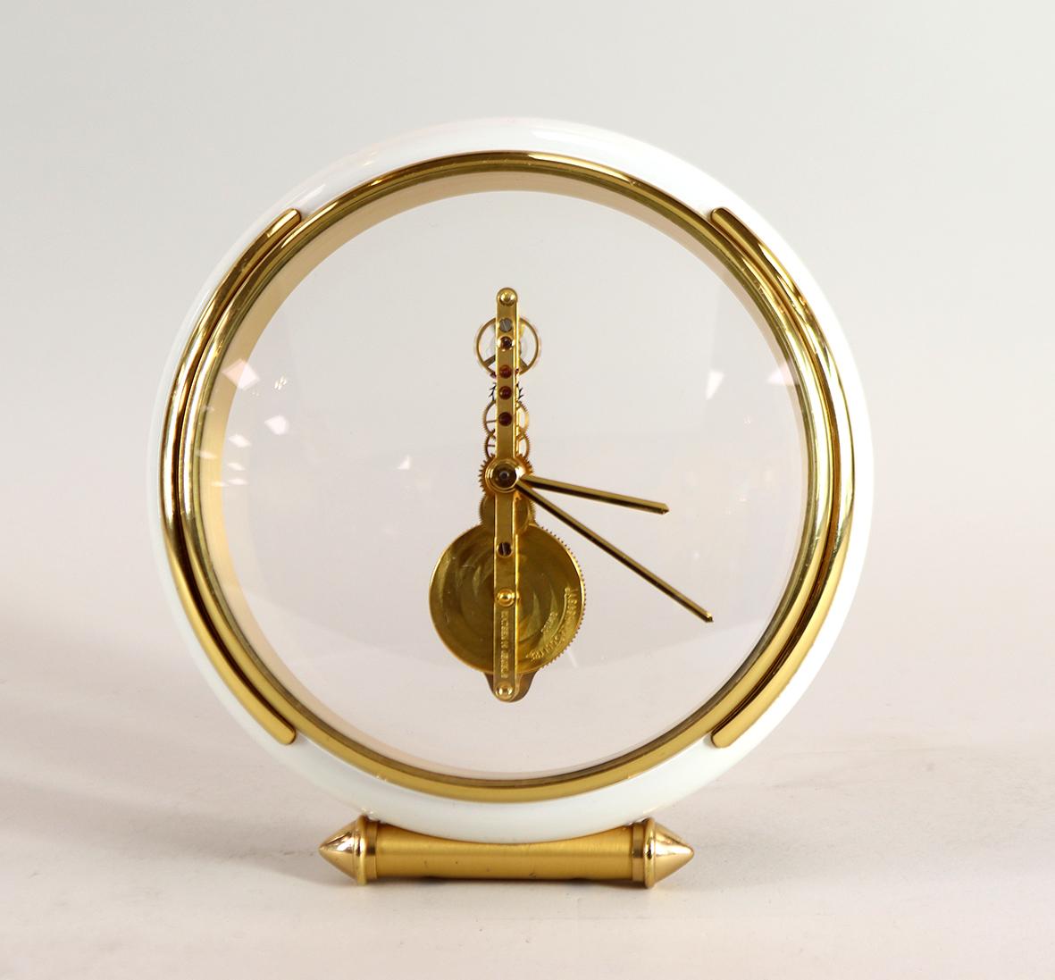 A stylish Jaeger-LeCoultre skeleton timepiece with a gilded 16 jewel inline or ‘baguette’ movement suspended behind convex glass. The bezel is of gilded brass with a white enamel surround all in excellent original condition. This Swiss made clock is