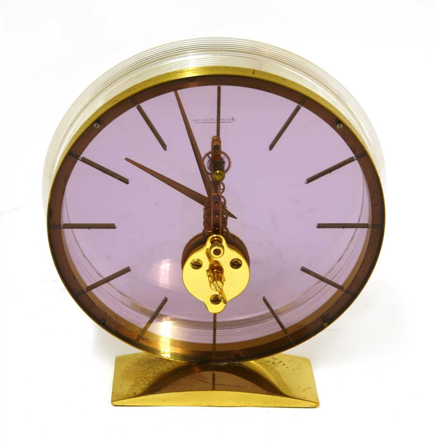 An exquisite Jaeger-LeCoultre Lucite and gilt metal skeleton table clock.

This elegant 20th century clock has baton numerals, the face is a beautiful translucent soft lilac and placed on a rectangular base.


Measure: 14.5cm diameter.
 