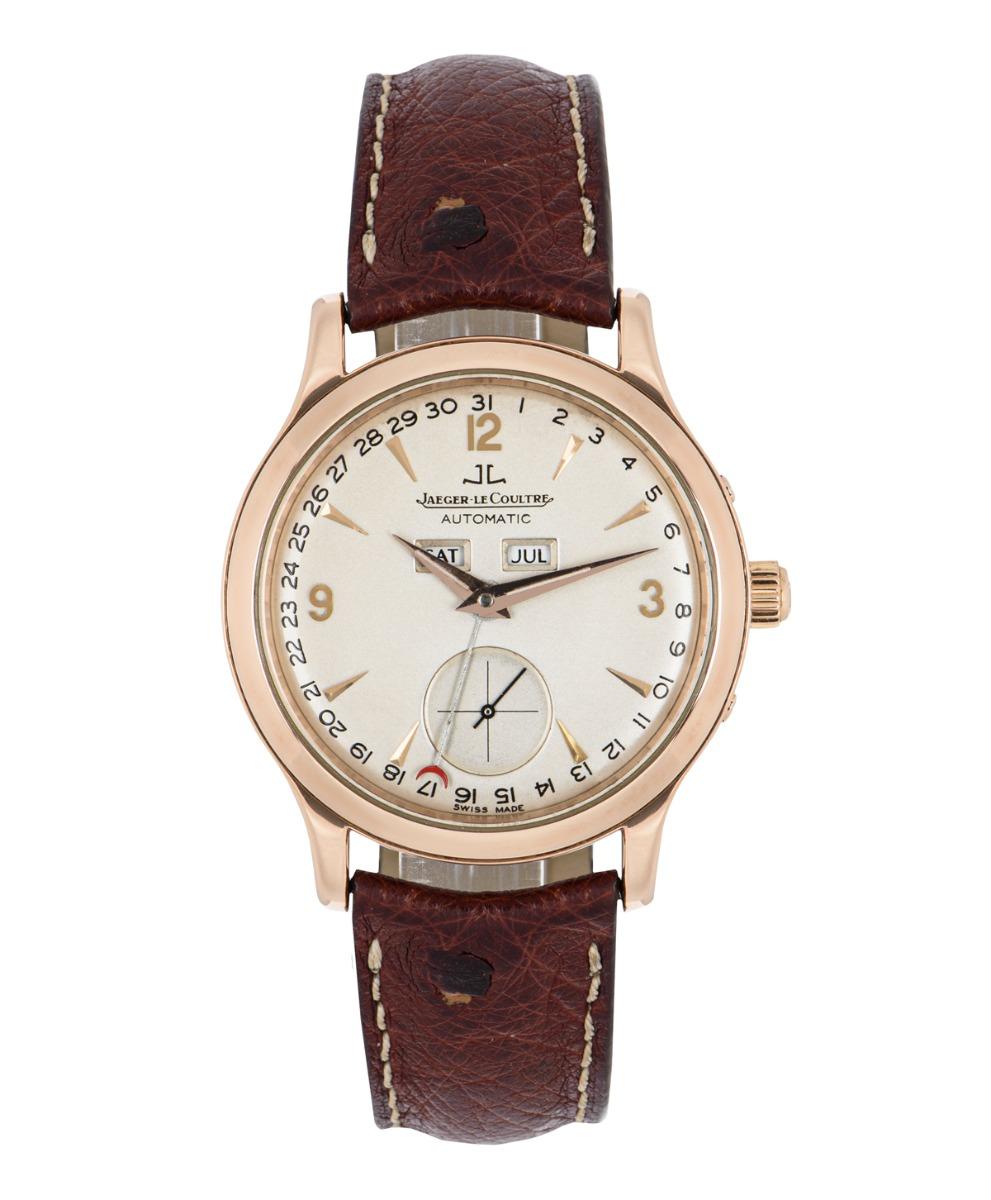 A rose gold Master Control Date Calendar by Jaeger LeCoultre. Featuring a silver dial with a day and month display just above the centre of the dial. The dial also displays the date around the edge which is indicated by the red-tipped hand, as well