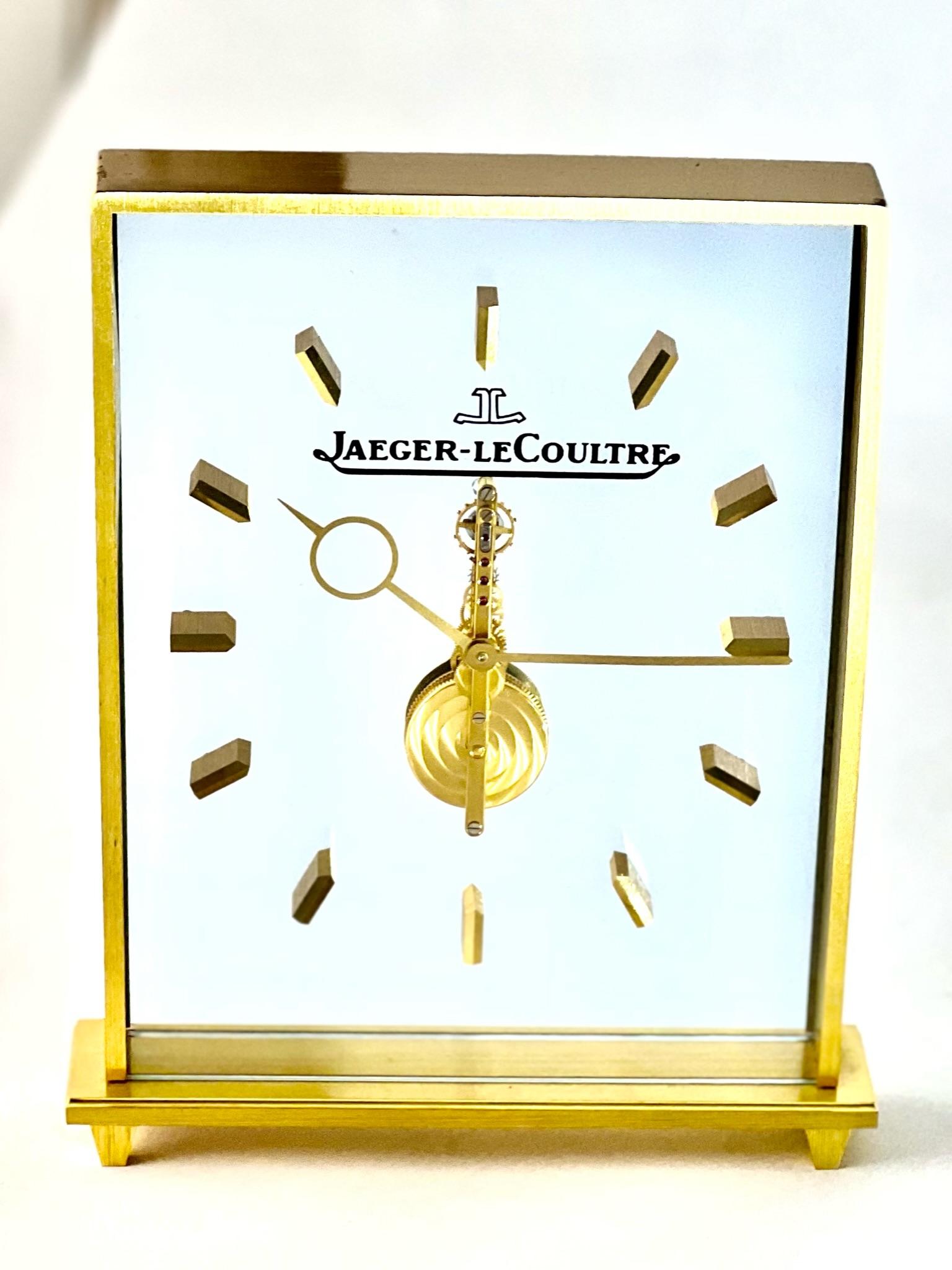 Stunning Jaeger LeCoultre inline skeleton clock, with a clean minimalistic design which would look stylish on a table, mantelpiece of desk. 

The stylish Jaeger LeCoultre logo is visible and lends a stylish ascetic to the clock. 

Made with gilt