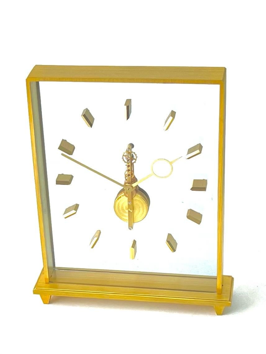 Stunning Jaeger LeCoultre inline skeleton clock, parading a clean minimalistic design suitable anywhere in the home, especially a table, mantelpiece or desk. 

Made with gilt brass and lucite, the beauty of these skeleton clocks is that you can