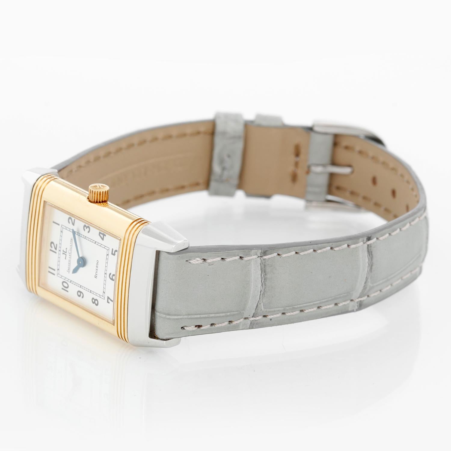 Jaeger LeCoultre Reverso 260.5.08 Stainless Steel and Yellow Gold Watch - Quartz. Stainless steel and Yellow Gold  ( 20mm x 32mm ). Silver dial with Arabic roman numerals and subdial at 6 o'clock.  JLC Light Spring Green strap with JLC signed