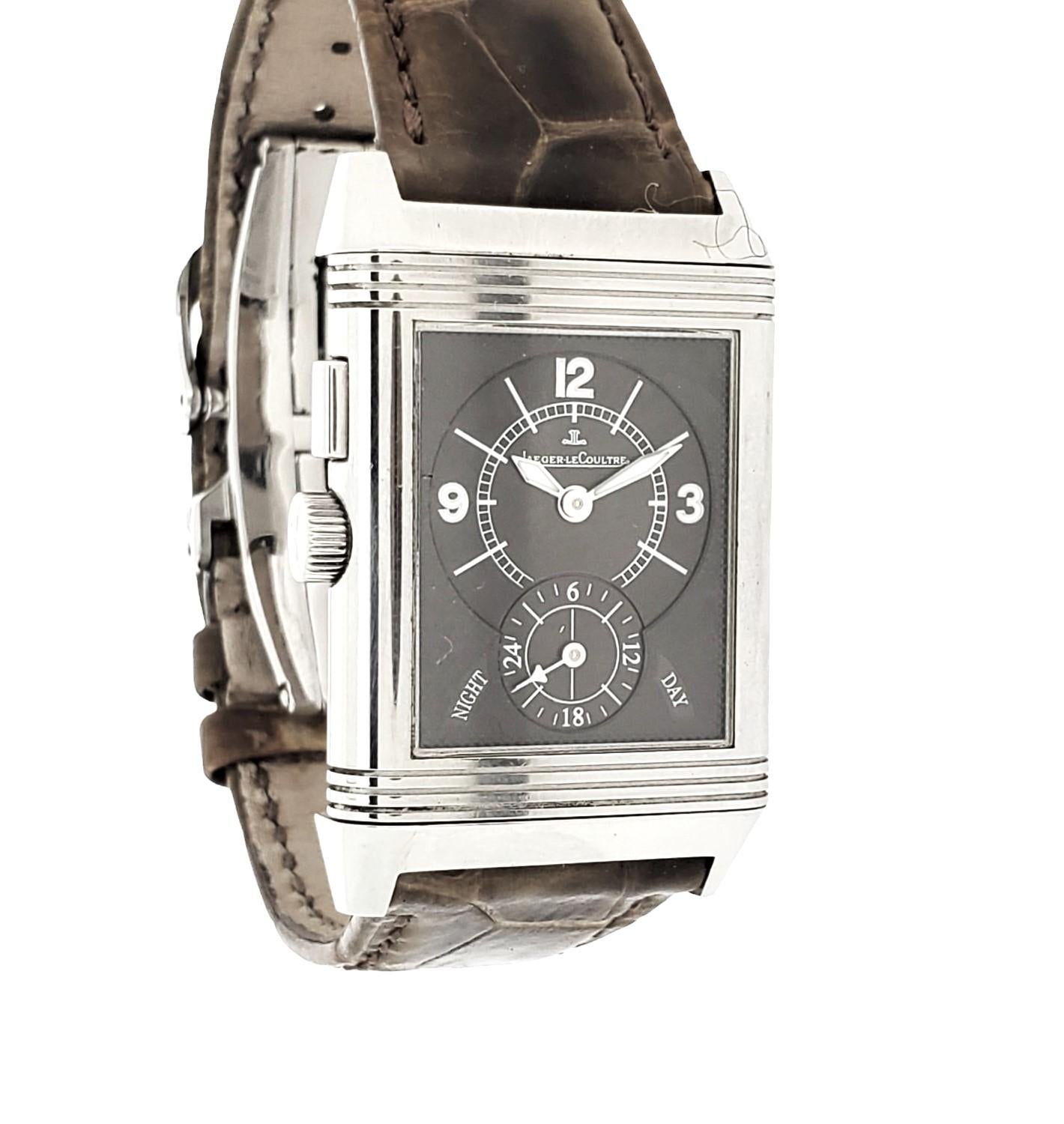 Jaeger LeCoultre Reverso Night & Day.  The watch comes with a Silver and slate Dial.  It also has the adjustment for 2 time zones.
The case is made of Stainless Steel & Alligator Strap w. Deployant Buckle
 42mm x 26mm Case Size
Condition: