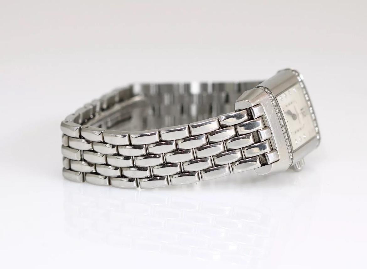 Up for sale is this gorgeous Jaeger-LeCoultre reverso stainless steel watch. This watch contains a white starburst dial with factory diamonds at all hour markers except for the 6 and 12 positions. This watch is made in Switzerland, ensuring