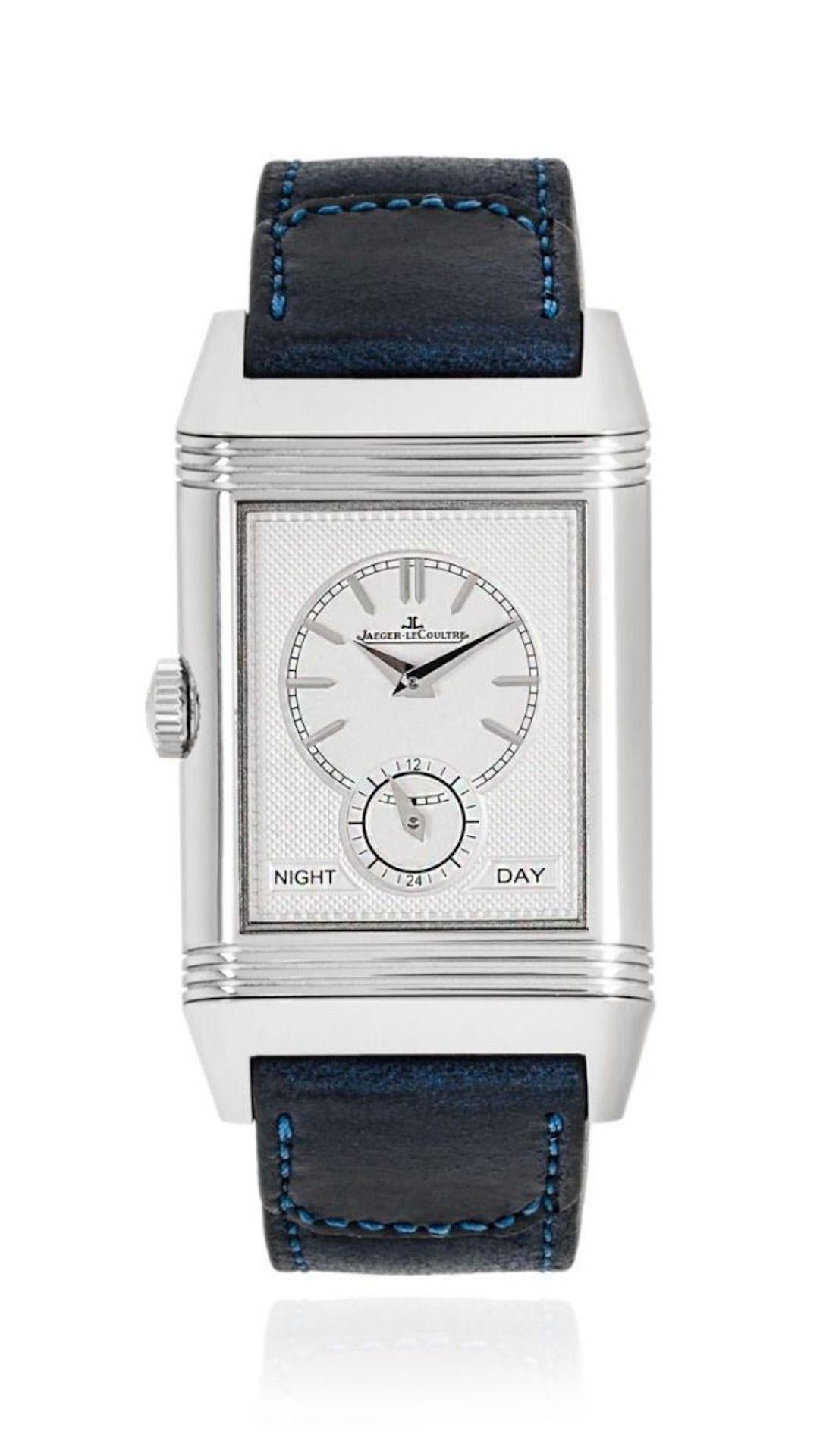 A stainless steel Jaeger LeCoultre Reverso Tribute Duoface. Featuring a blue dial with applied hour markers, a small seconds sub-dial and a reversible side which features a silver dial and displays two time zones, as well as a practical day/night