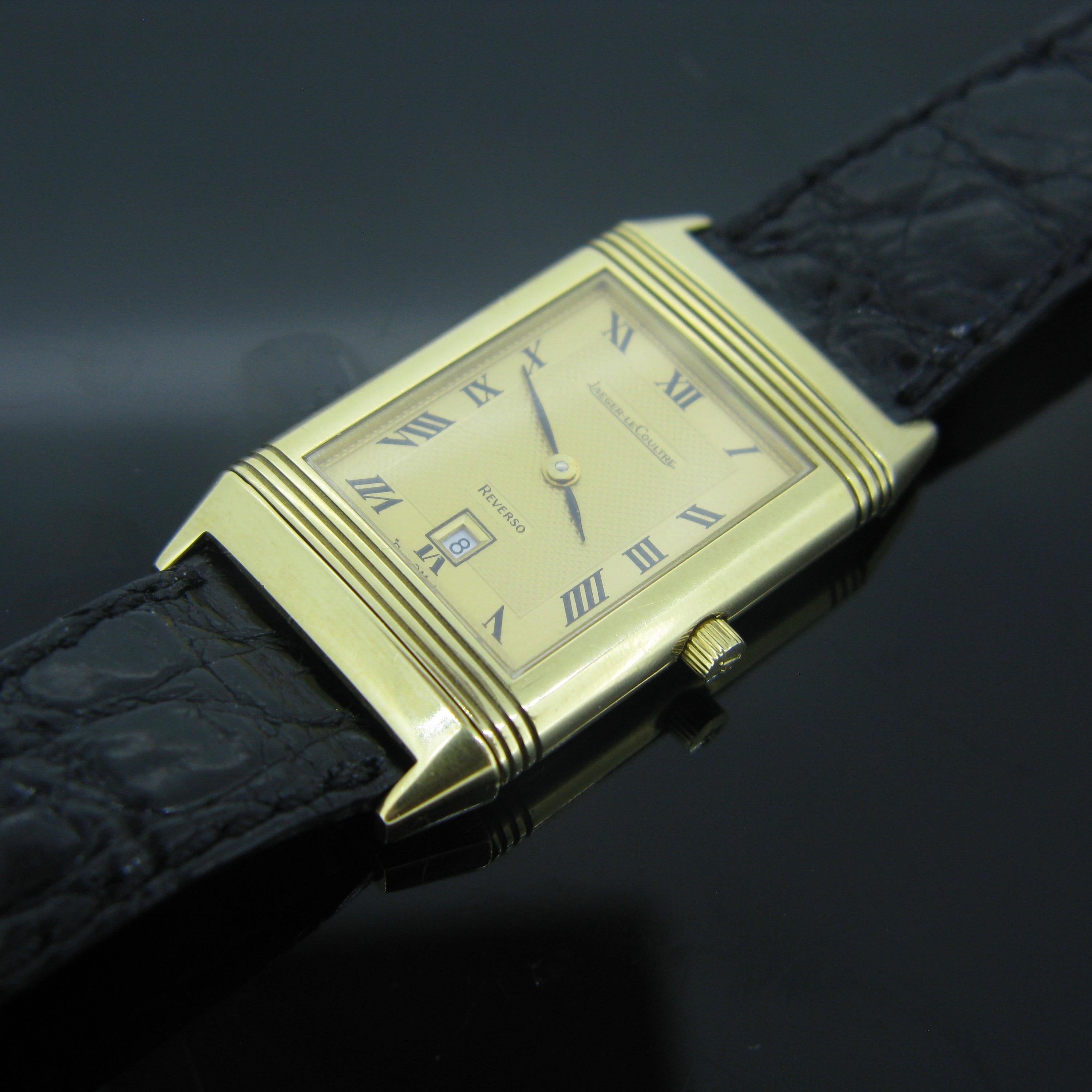 The dial is yellow with black Roman numerals. The square case is made in 18k Yellow Gold. The strap is in black leather and with a gold plated clasp signed JL. It is hallmarked with the Swiss hallmarks for 18kt gold and with the maker’s mark. It is