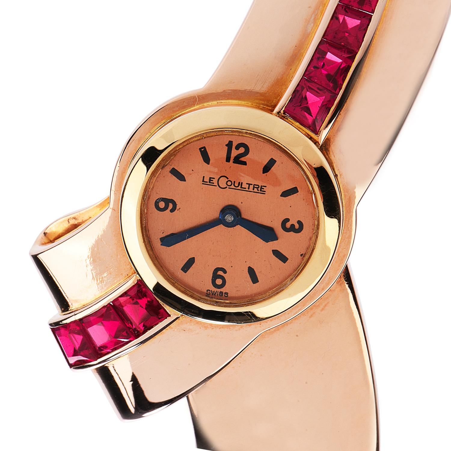 This vintage retro Jaeger LeCoultre piece is the perfect balance of a crossover cuff bracelet and watch, 

Crafted in pure 25.3 grams of 18K rose gold. Features (9) Square cut, channel set, synthetic rubies of approximately 3.50 carats.

 This