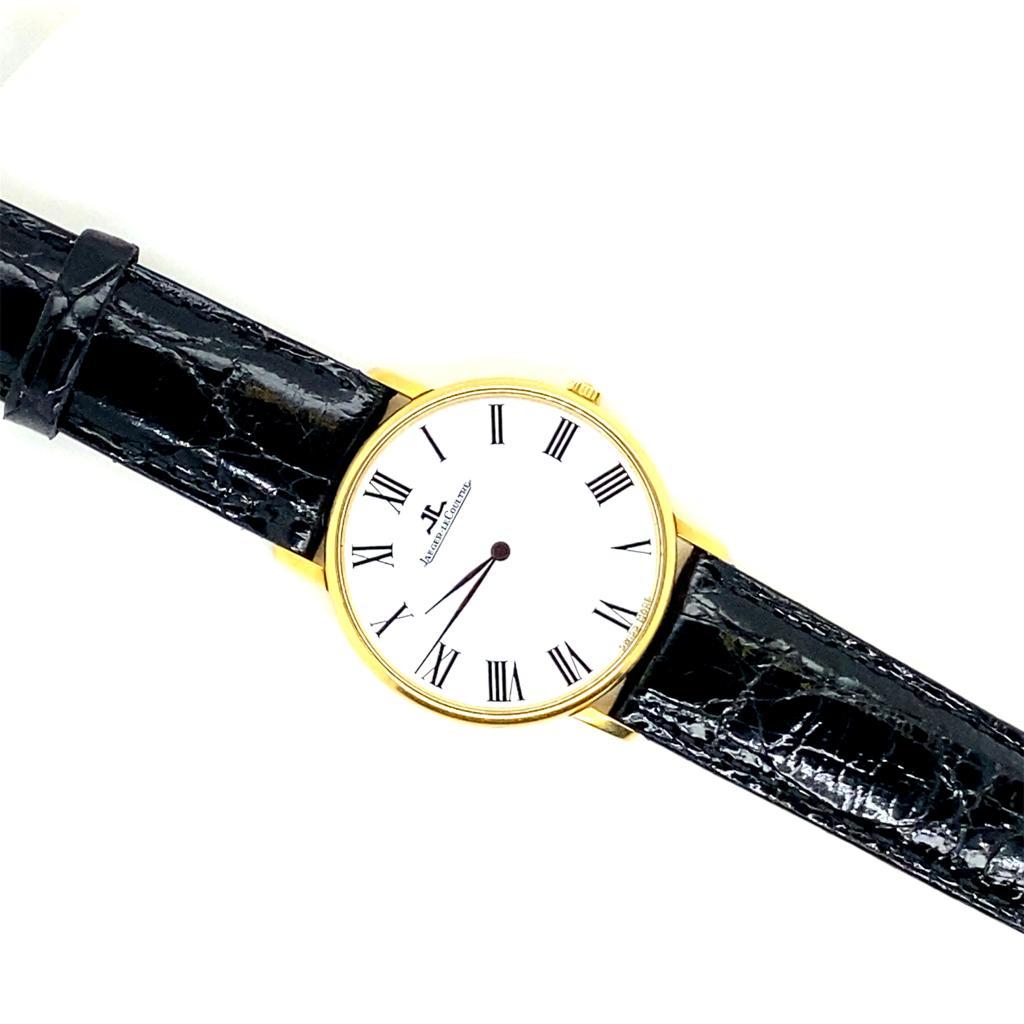 A Jaeger LeCoultre watch in 18 karat yellow gold, manual wind 9226.21, circa 1980.

This elegant wrist watch has a manual movement with a round 18 karat yellow gold case measuring 33mm x 33mm.

With a white dial the wristwatch has Roman numeral hour