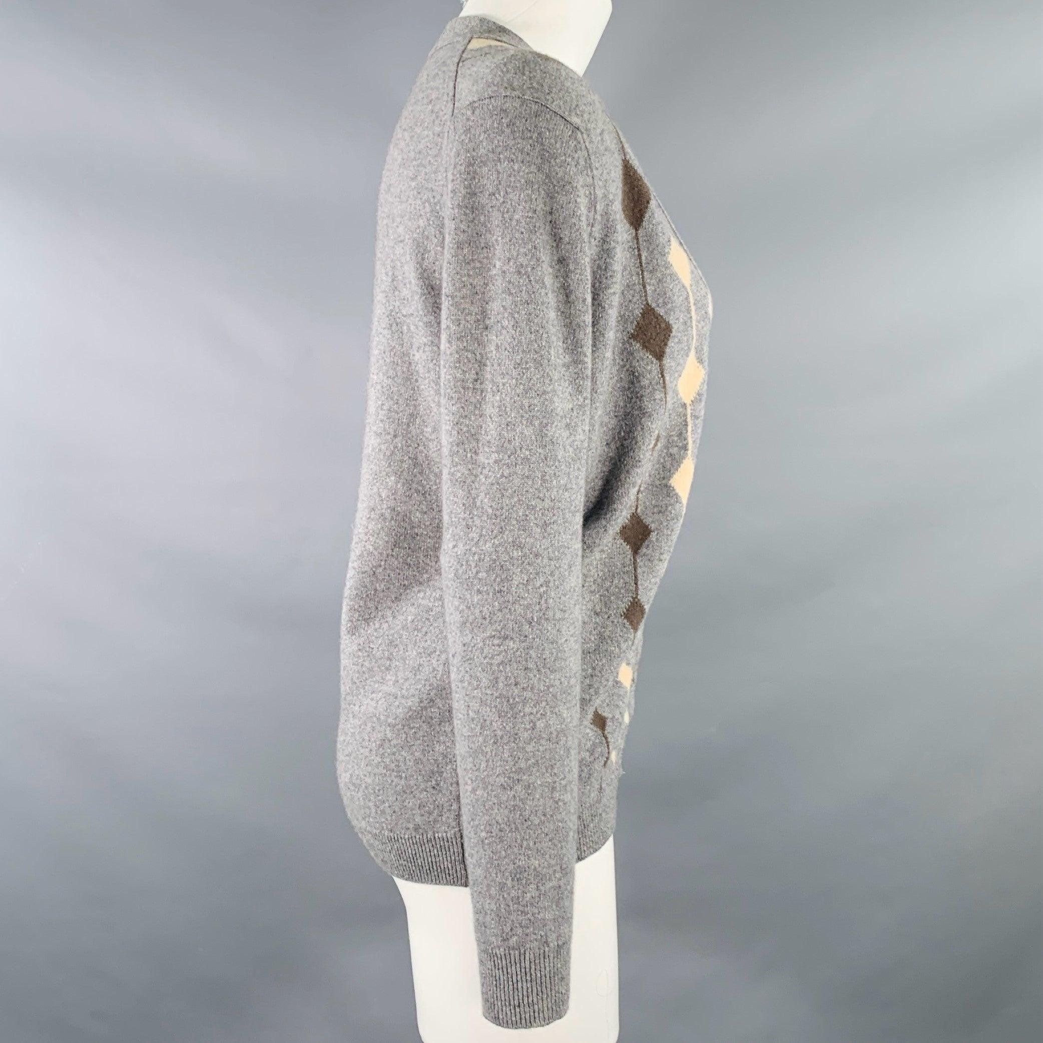 JAEGER cardigan
in a grey cashmere knit featuring cream and brown diamond pattern, V-neck, and button closure. Made in UK. Very Good Pre-Owned Condition. Missing top button, minor pilling. 

Marked:   91 cm. / 36 inches  

Measurements: 
 
Shoulder: