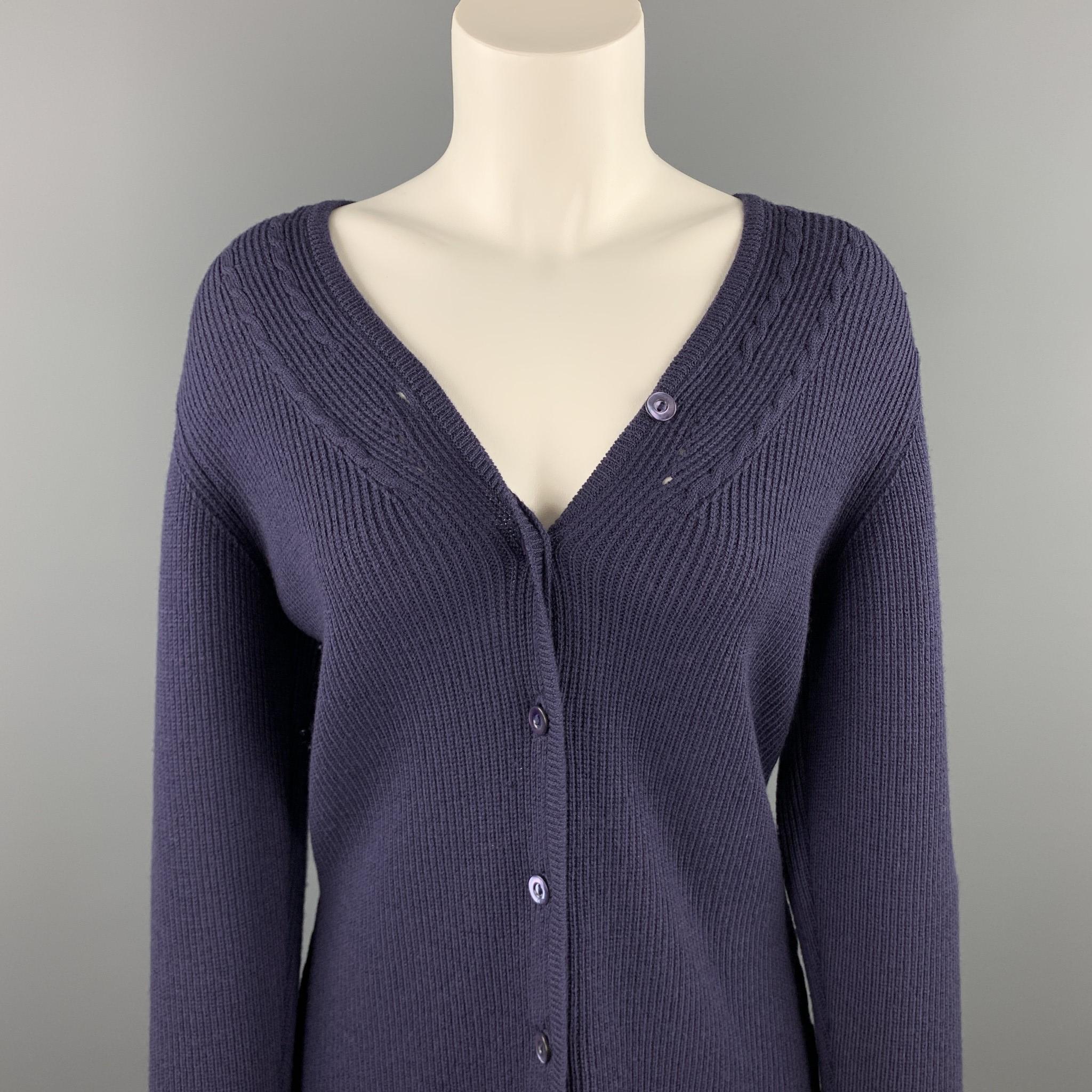 JAEGER cardigan comes in a navy ribbed merino wool featuring a buttoned closure. Made in England.

Very Good Pre-Owned Condition.
Marked: M

Measurements:

Shoulder: 15.5 in. 
Bust: 37 in. 
Sleeve: 26 in. 
Length: 25 in. 