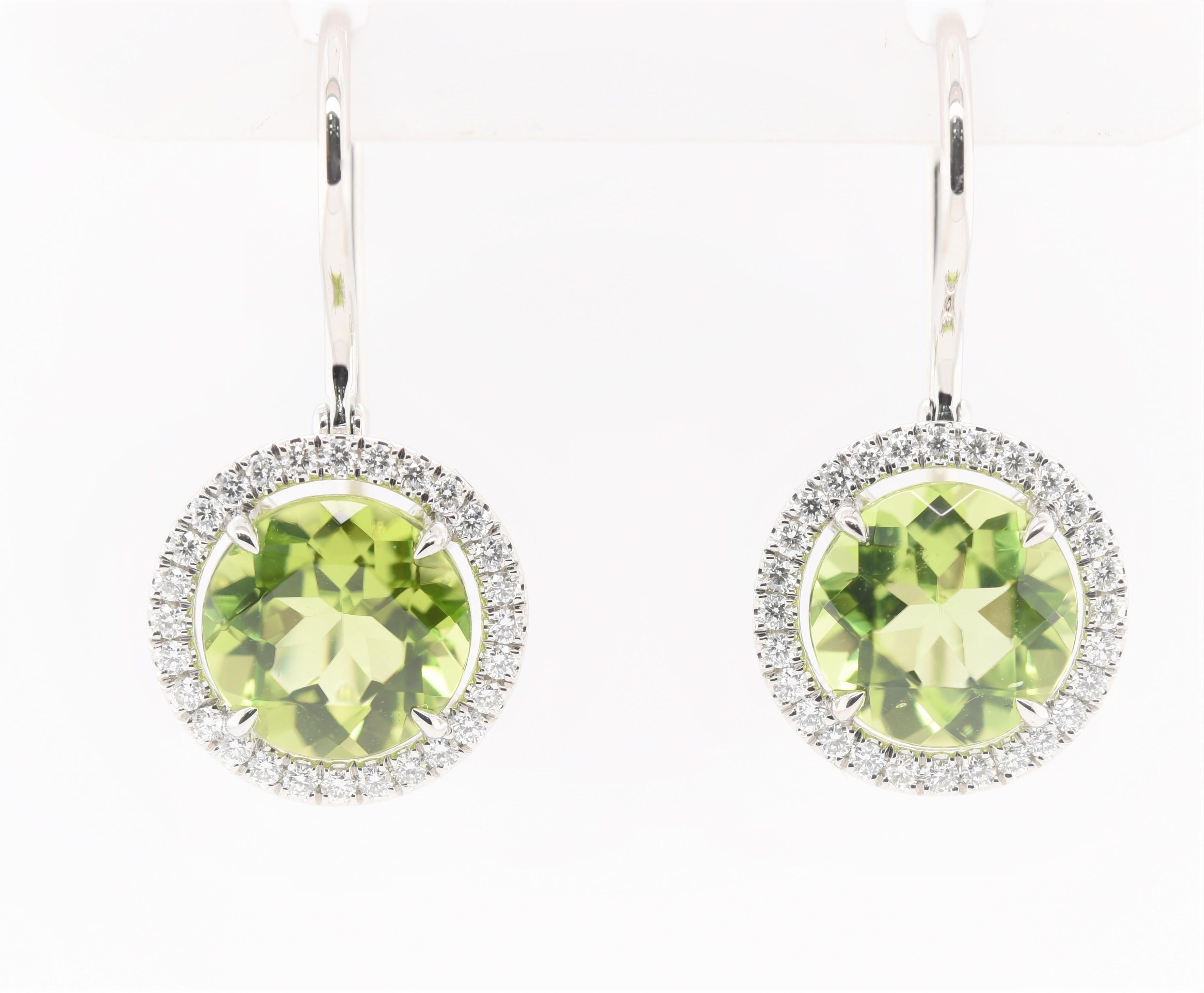 Peridot and Diamond Halo Earrings with over 3 1/3 carats in Peridot and over 1/2 carats in diamonds for a total carat weight of 4 carats all set in platinum. 
