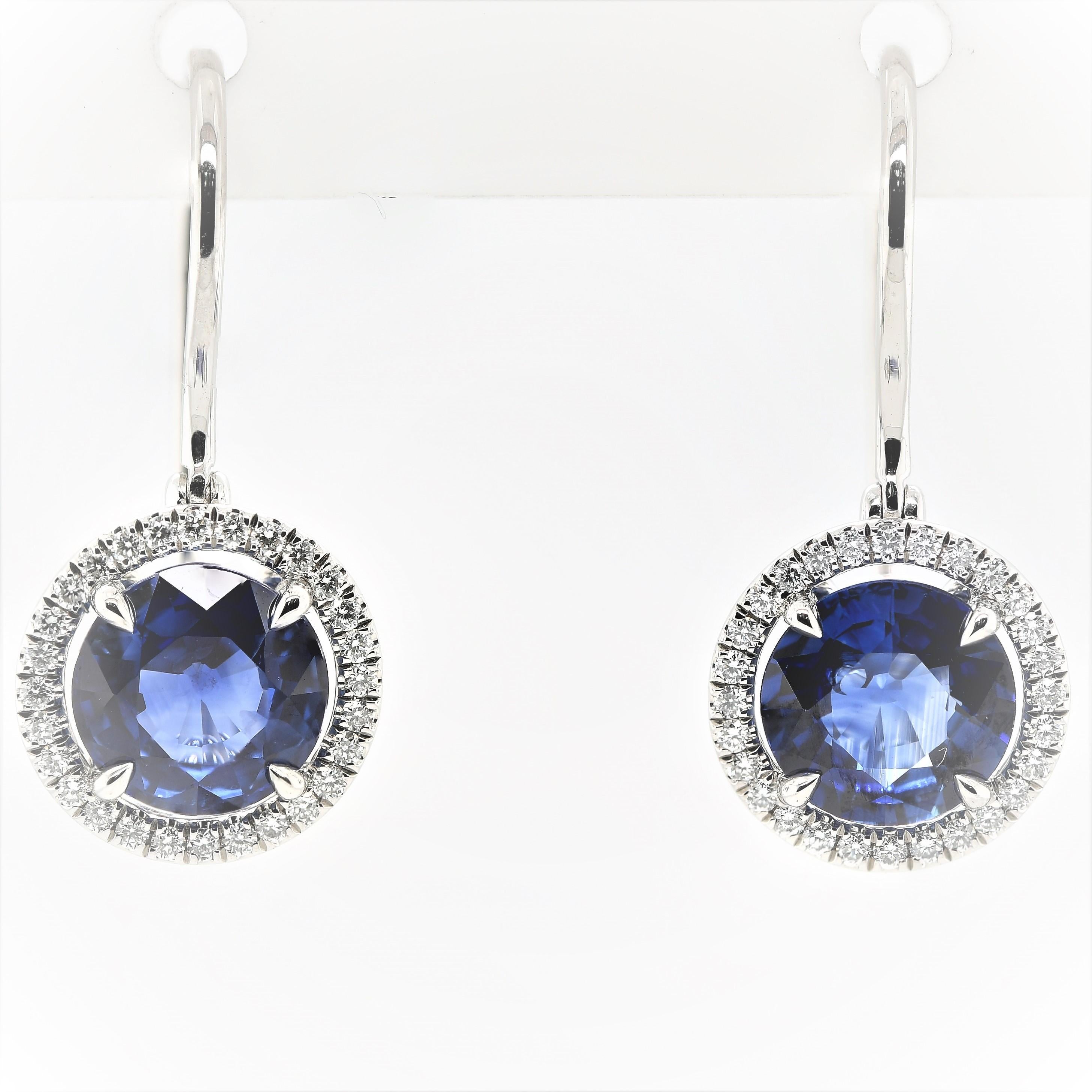 These Sapphire and Diamond Halo Earrings are a must have for any wardrobe! With over 2.10 carats in Sapphires and 56 Diamonds all set in Platinum, they will surely complement any outfit!