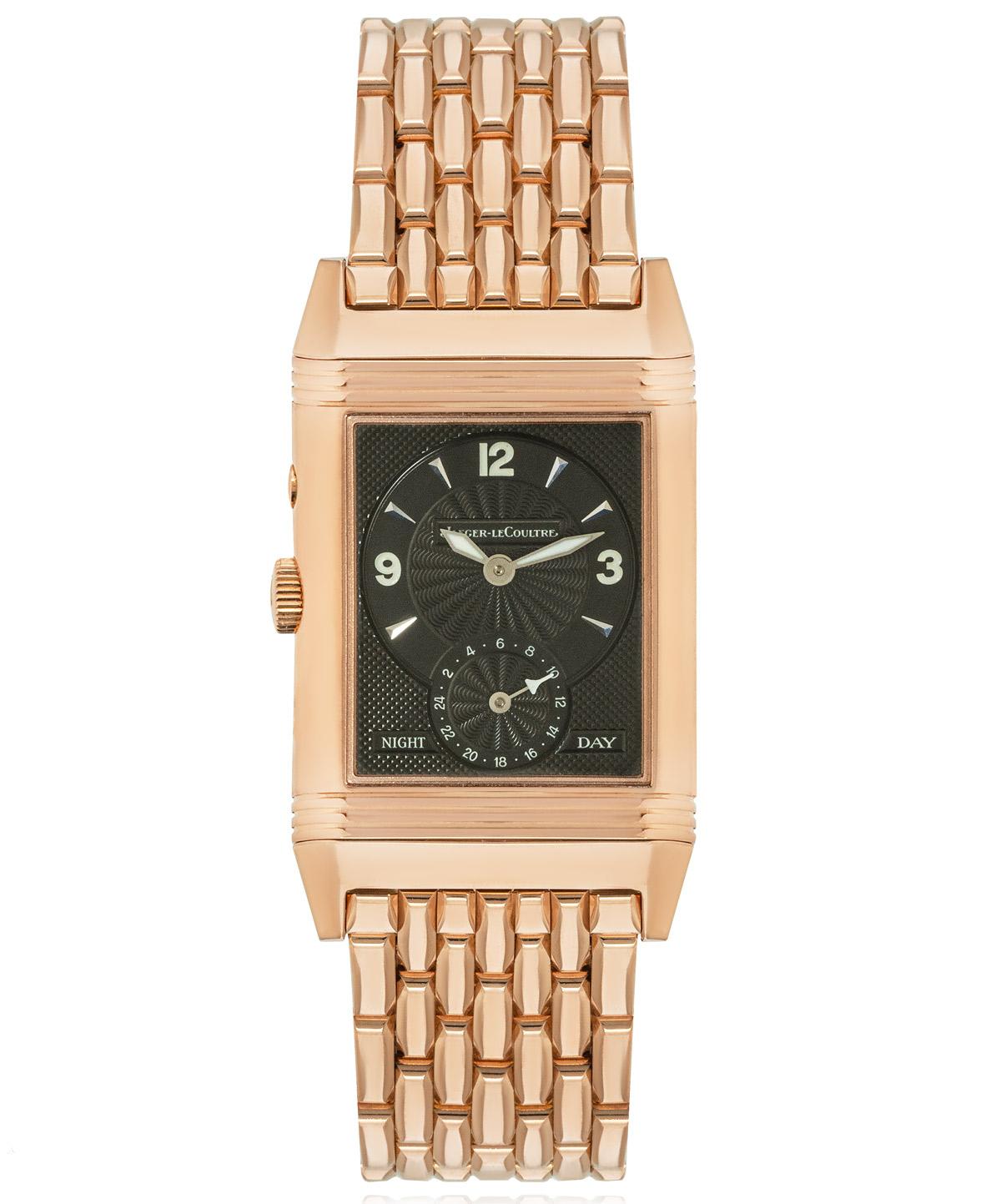 A 26mm rose gold Reverso by Jaeger LeCoultre. Features a silver dial with arabic numbers, a small seconds and a reversible side featuring a black dial with a day/night indicator as well as a second time zone which can be adjusted via a simple push