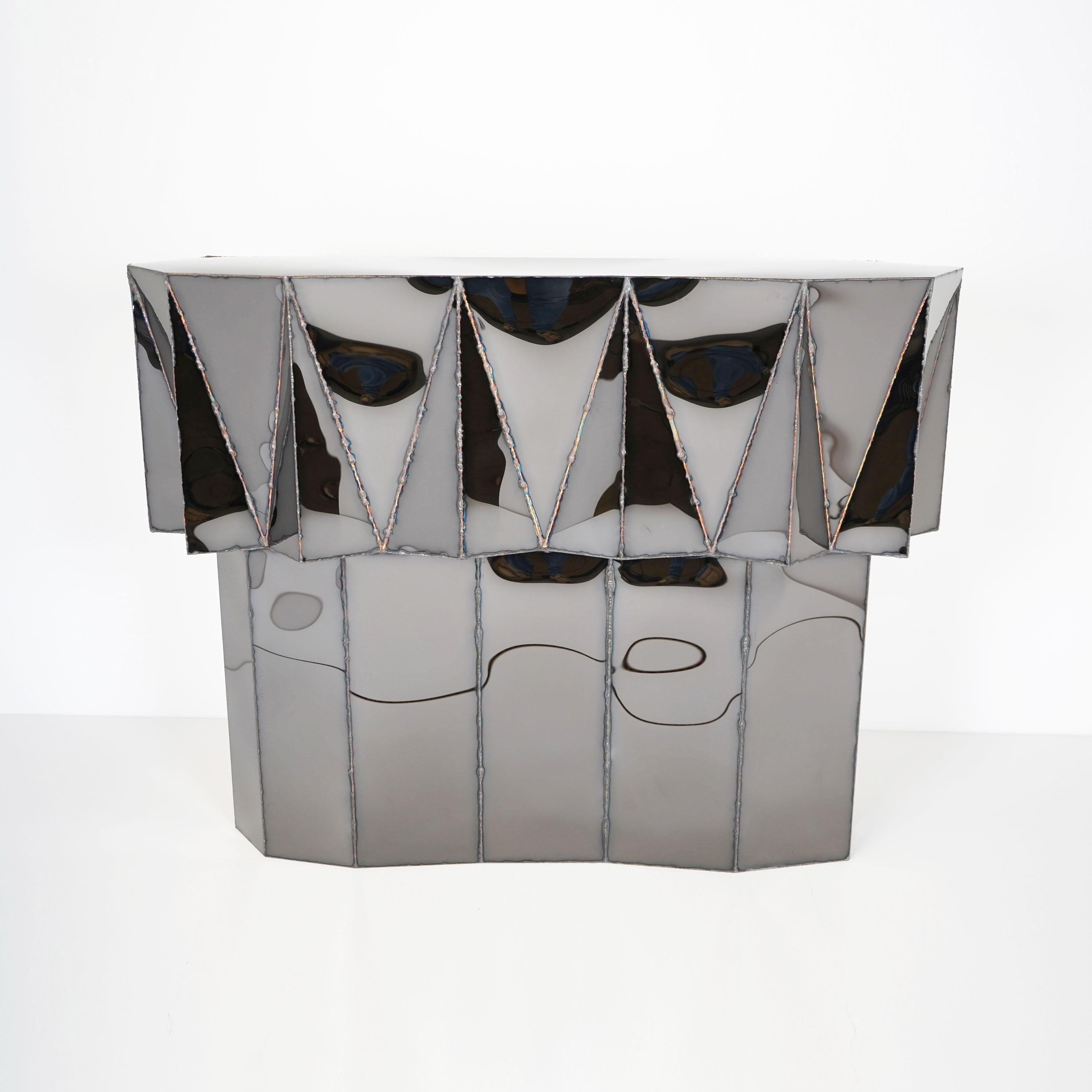 Jagged Edge Console in Welded Mirror-Polished Stainless Steel by Julian Mayor
Limited Edition of 8 + 4AP.
Dimensions: D 30 x W 118 x H 89 cm. 
Materials: Mirror-polished stainless steel.

Julian Mayor is a British artist and designer renowned for