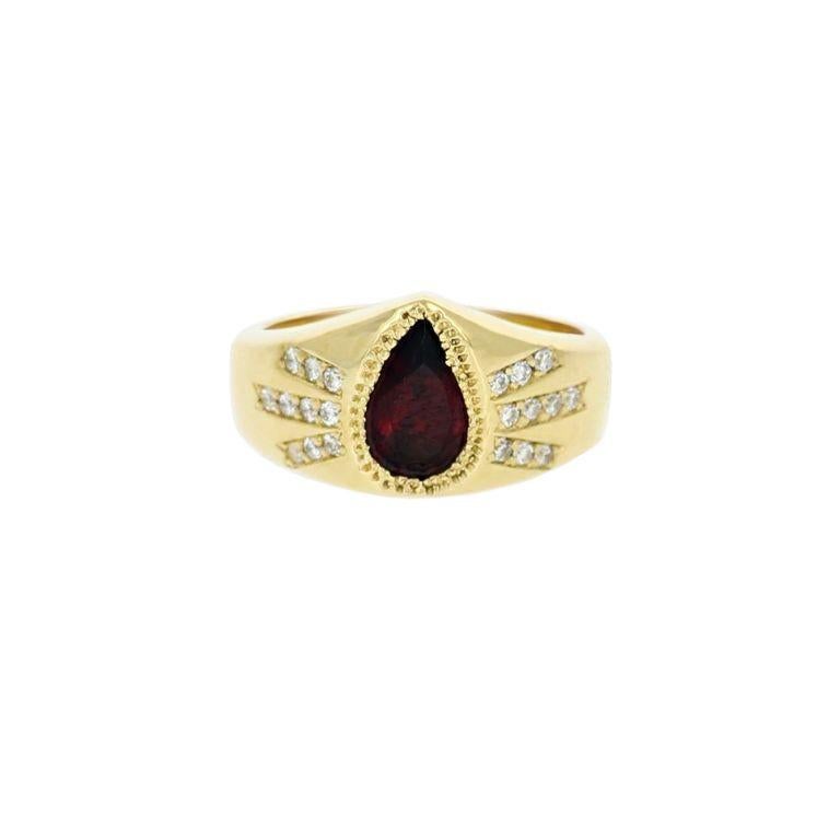The Jagger Diamond Signet Ring is a stunning, one-of-a-kind design, meticulously handcrafted using an ancient wax-carving technique. Crafted in 18kt yellow gold, it features a captivating pear-shaped garnet at its center, surrounded by a dazzling