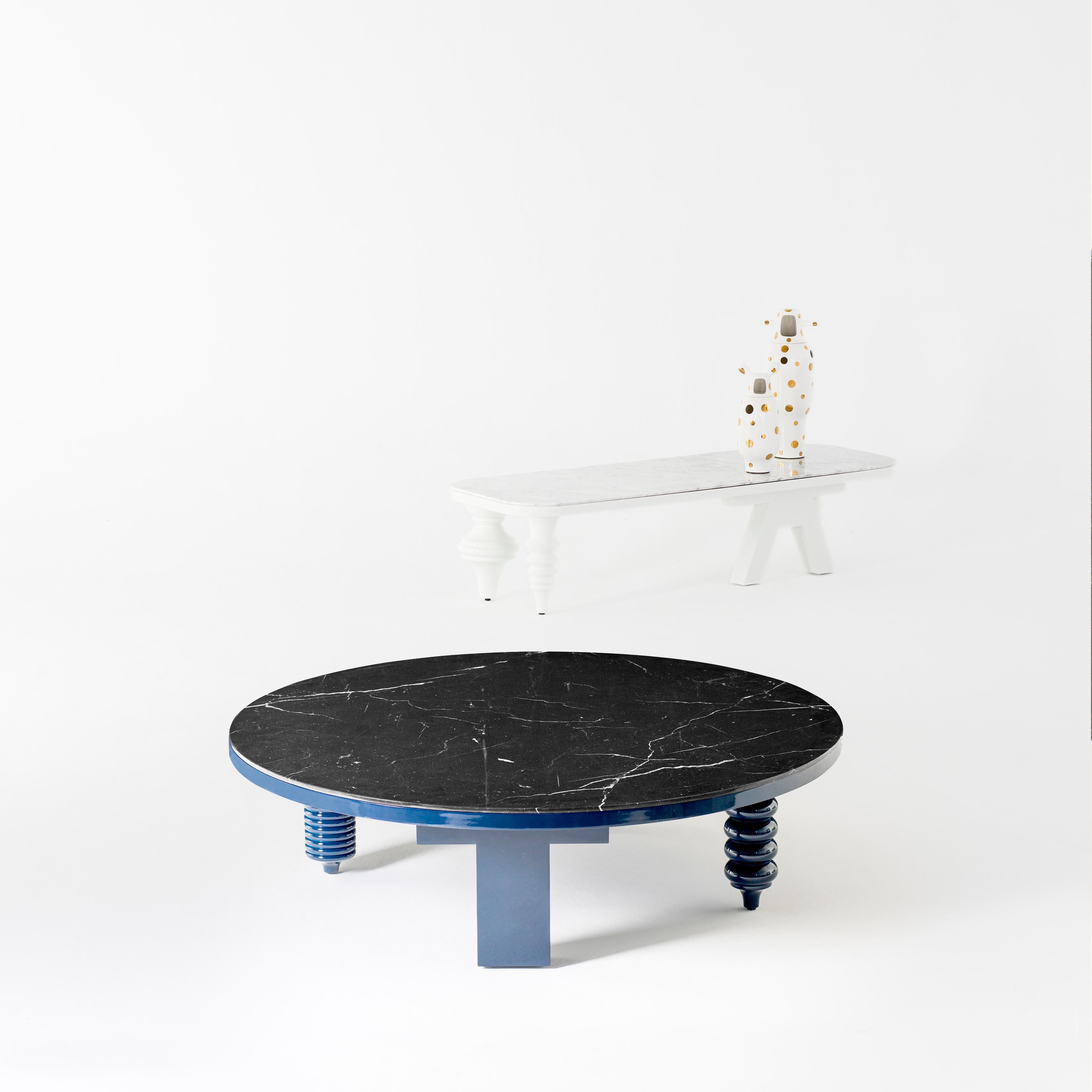 MDF base and legs in turned solid alder wood, lacquered in blue gloss 
Marble table tops in Carrara Venato or Nero Marquina.

Rounded table measures:
Ø 80/120x H.35 cm.