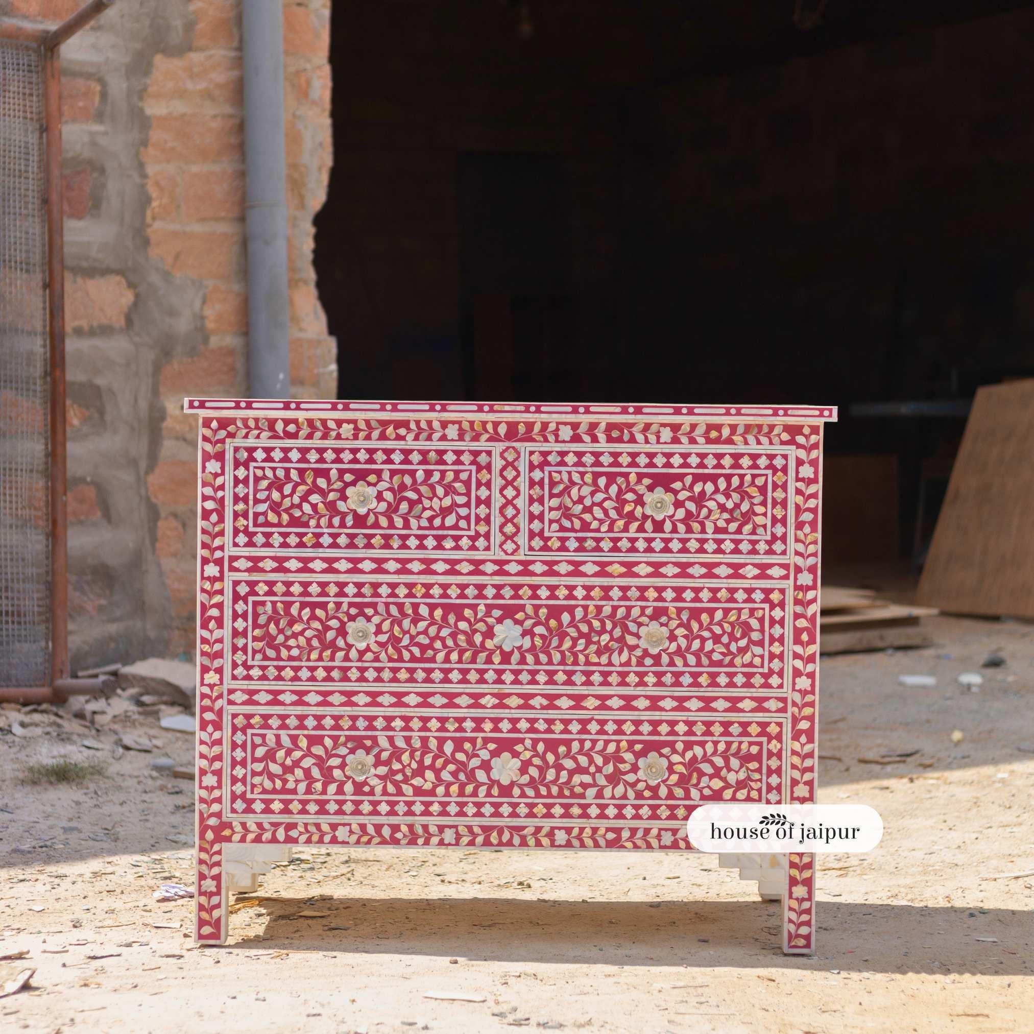 A stunning expression of traditional craftsmanship, this Pink Mother of Pearl Inlay Chest of Drawers captures the romance of traditional artistry blended with functional elegance. Each piece is meticulously handcrafted, featuring delicate floral