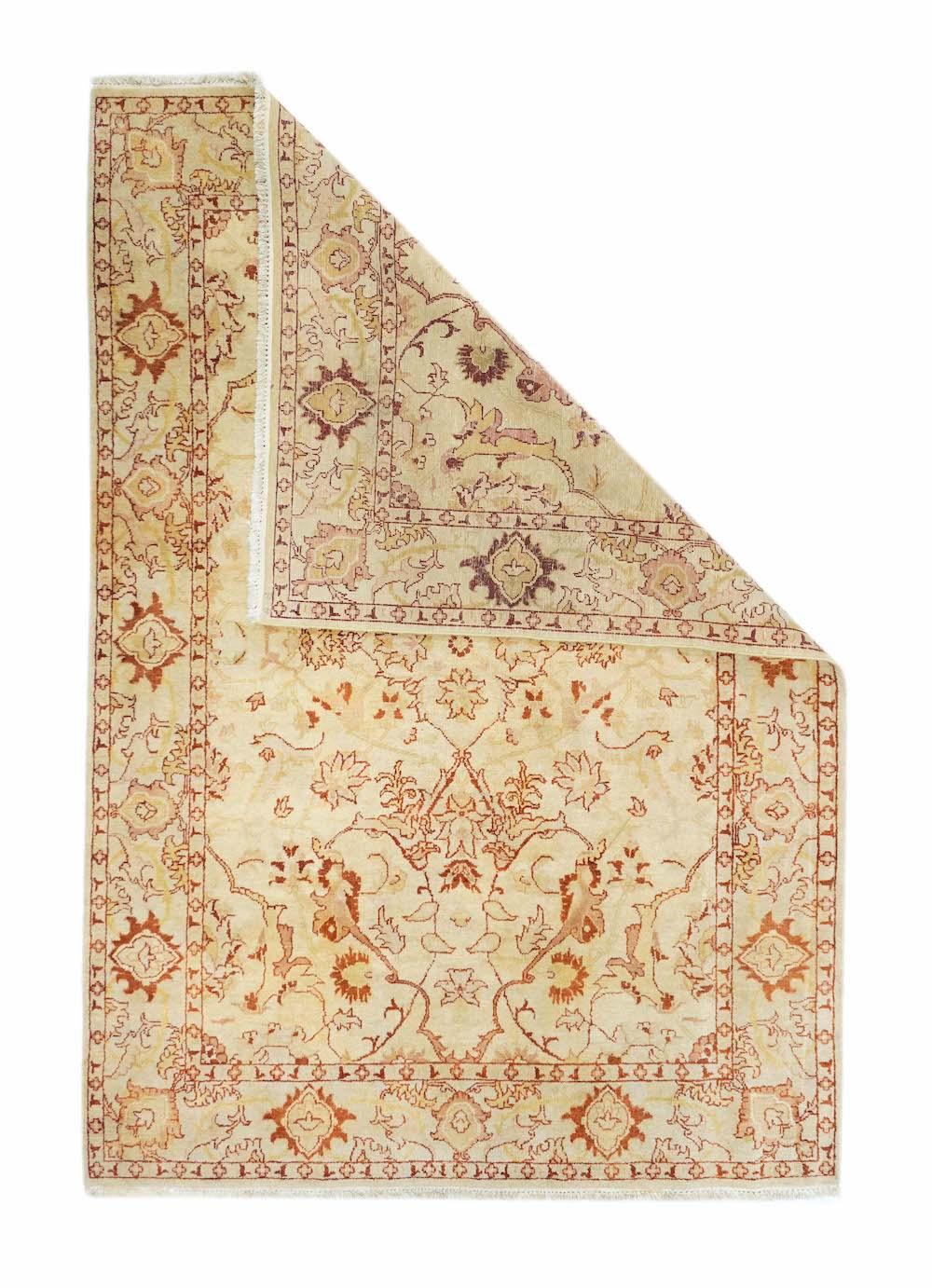 Jaipur Rug 5'11'' x 9'0''. This northern Indian, well-woven piece shows an ecru field centred by an open four palmette indented cruciform, escutcheon open arabesque pendants, and a scatter of forked acanthoids and petal palmettes. Ecru corners