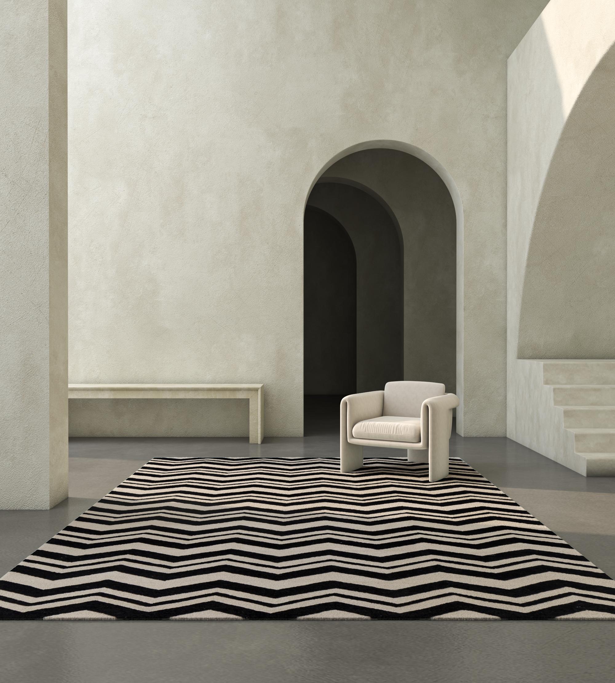 Jaipur Rugs Die Adrift Collection ist eine kühne Erkundung der Kontraste, bei der auffällige Schwarz-Weiß-Muster die Grundlage für jedes Stück bilden. Diese monochromen Elemente sorgen für eine starke, zeitlose Aussage, während kräftige Farbtupfer