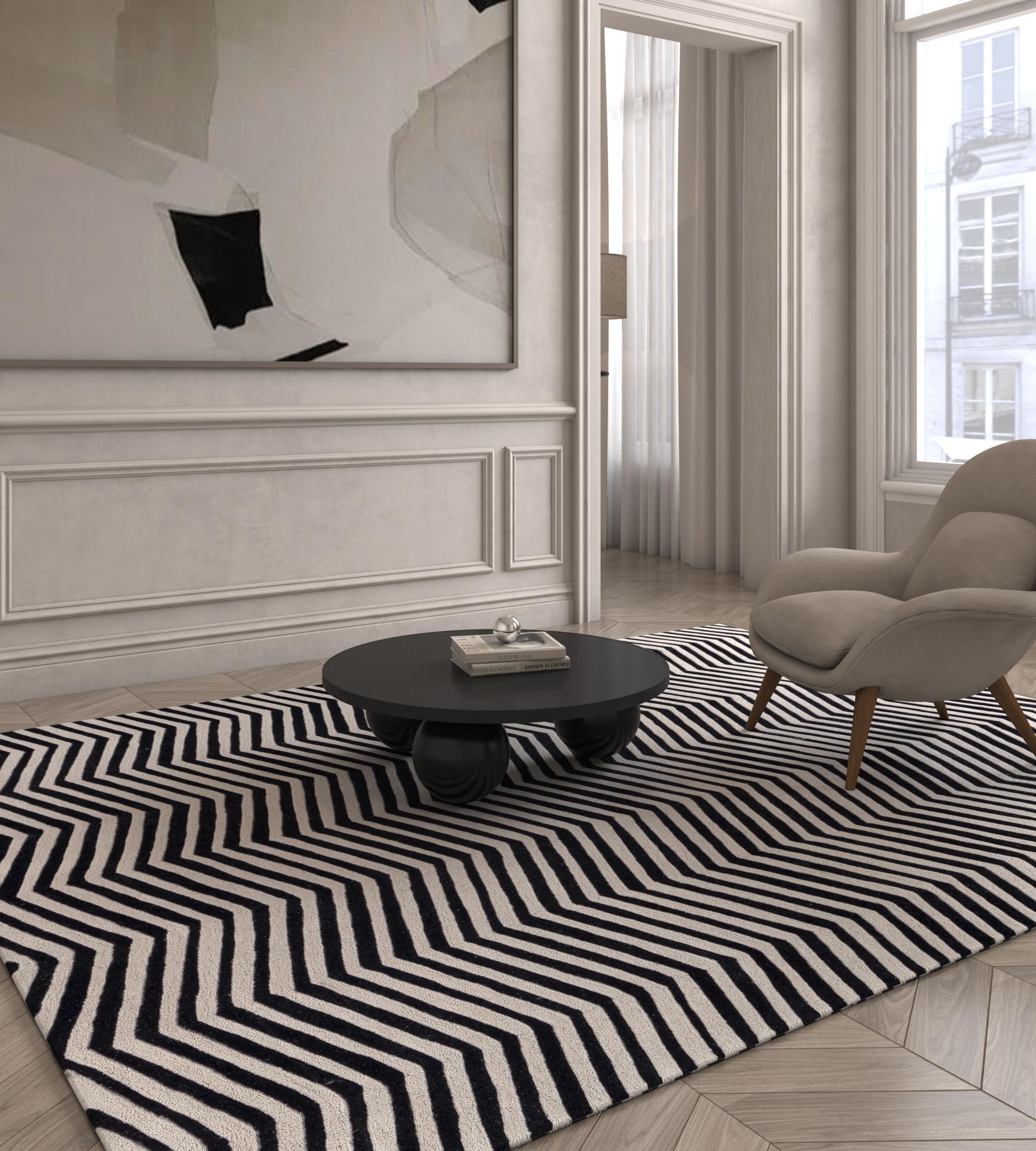 Jaipur Rugs The Adrift Collection is a bold exploration of contrasts, where striking black and white designs form the foundation of each piece. These monochromatic elements create a strong, timeless statement, while vibrant splashes of color