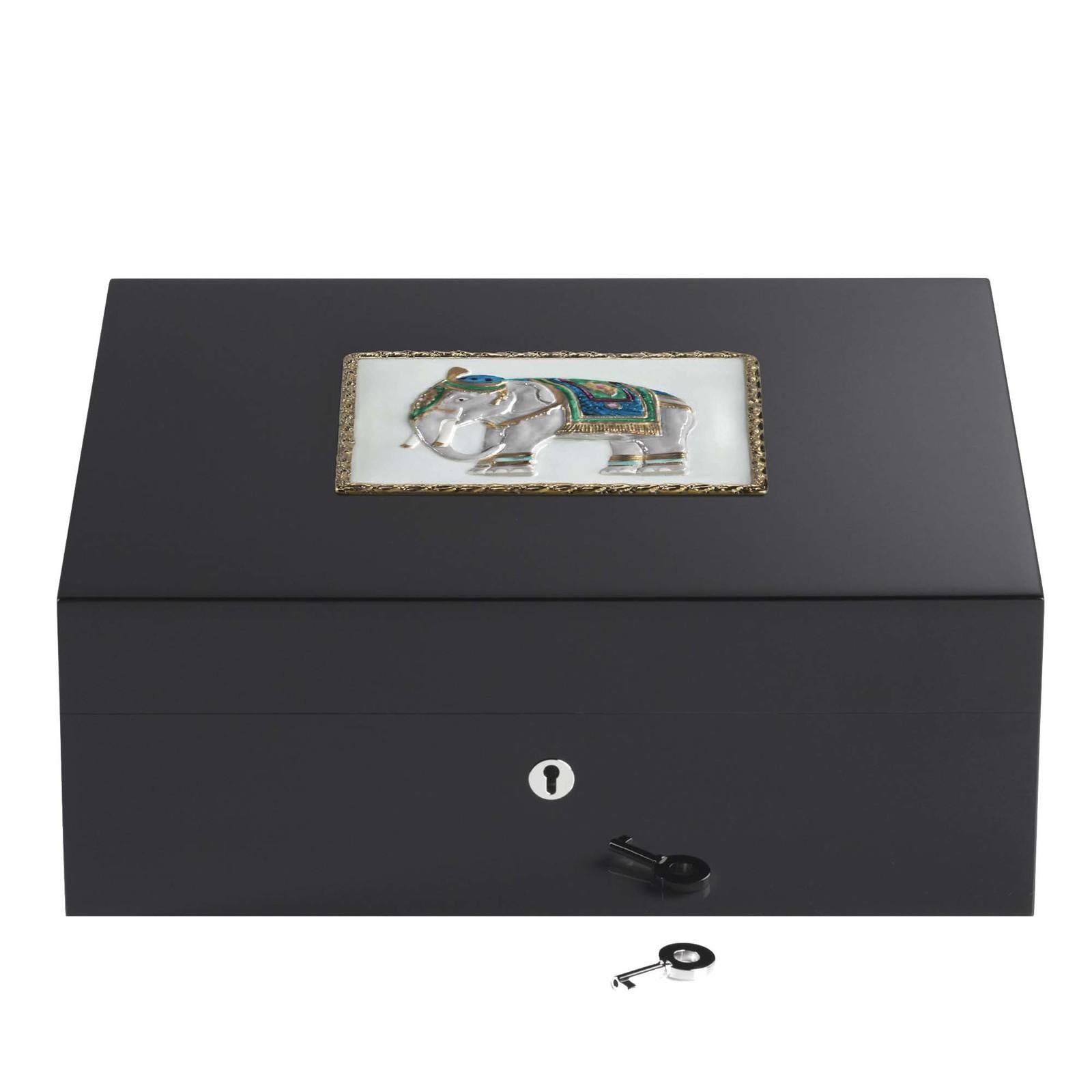A majestic elephant rendered in fine details and vibrant colors graces the lid of this stunning humidor for 75 cigars. A superb object of functional decor, this piece can make a well-received gift. It is made of wood with a humidity-control system