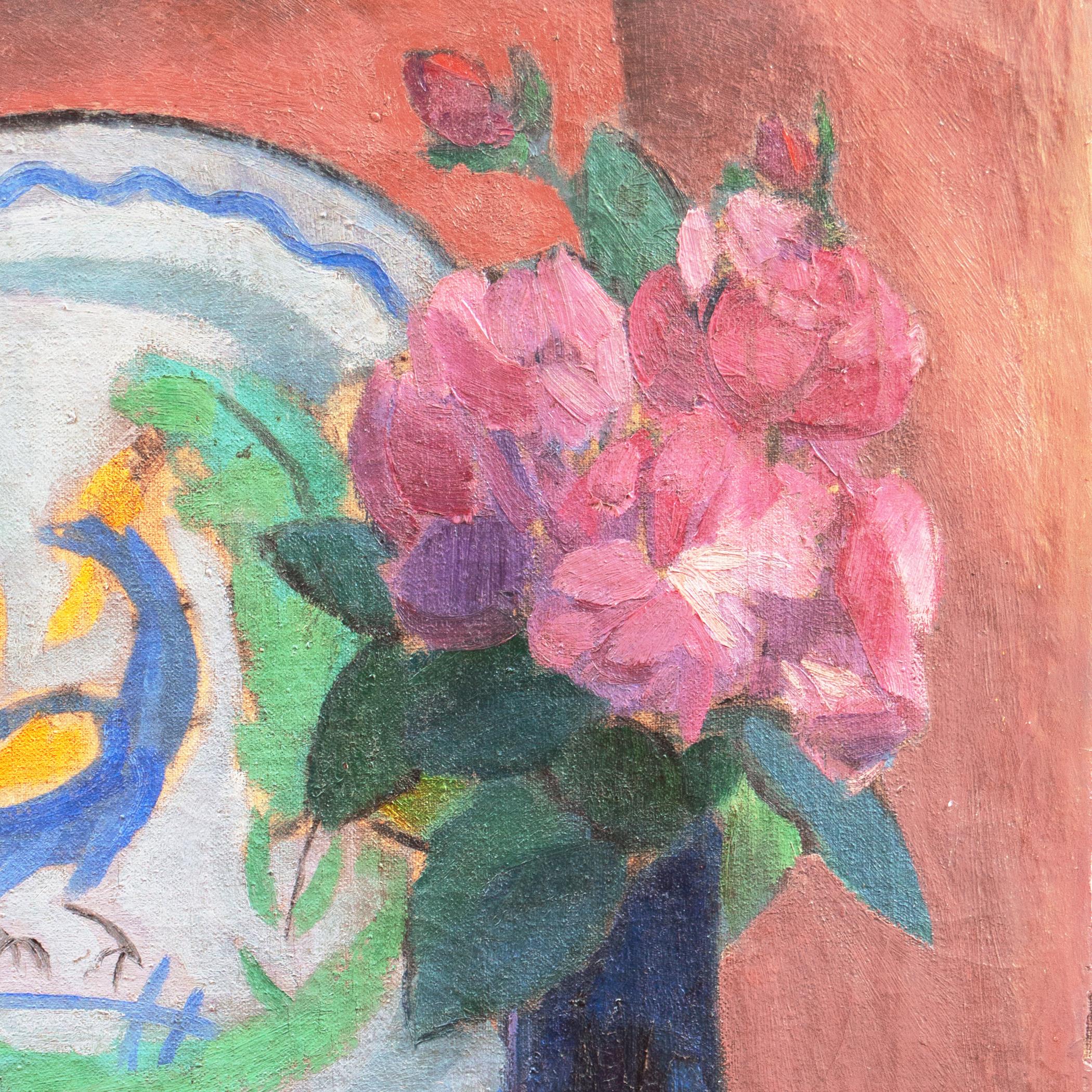 Signed lower right 'Jais' for Jais Nielsen (Danish, 1885-1961) and dated 1913. 

An early twentieth-century, oil still-life of pink dog-roses shown loosely arranged in a cobalt blue glass vase, set beside two Breton tin-glazed earthenware plates,
