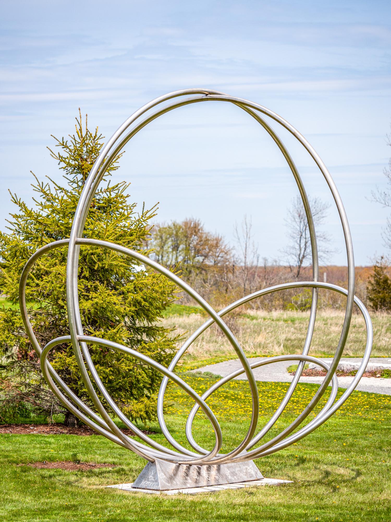 Six Rings - large, symmetric, abstract, rings, stainless steel outdoor sculpture - Contemporary Sculpture by Jake Goertzen