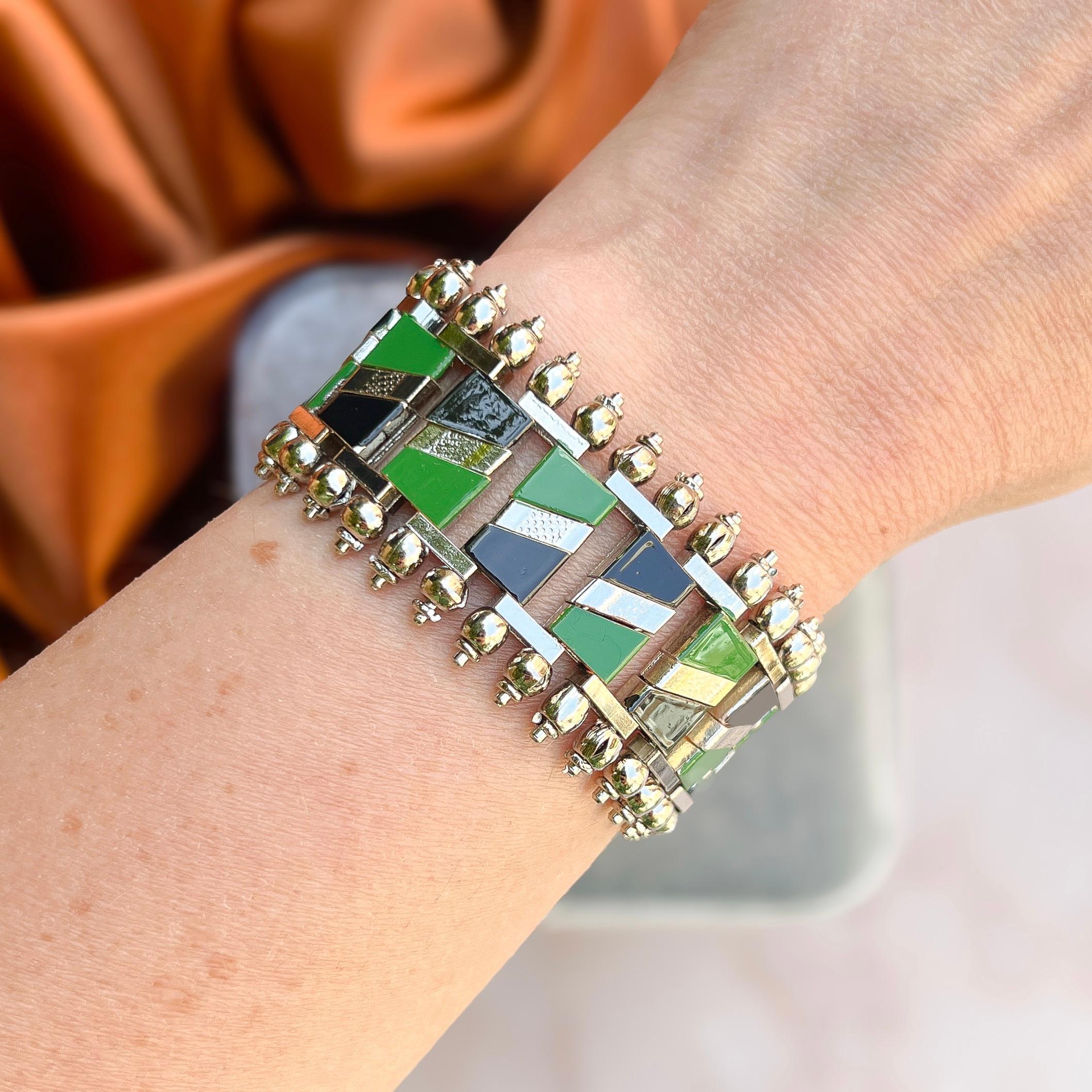 This stylish bracelet dates from the 1930s and was created by Jakob Bengel. 

Condition Report:
Excellent

The Details...
This bracelet is constructed from chrome plated metal. The bracelet is detailed with black and green enamel in geometric