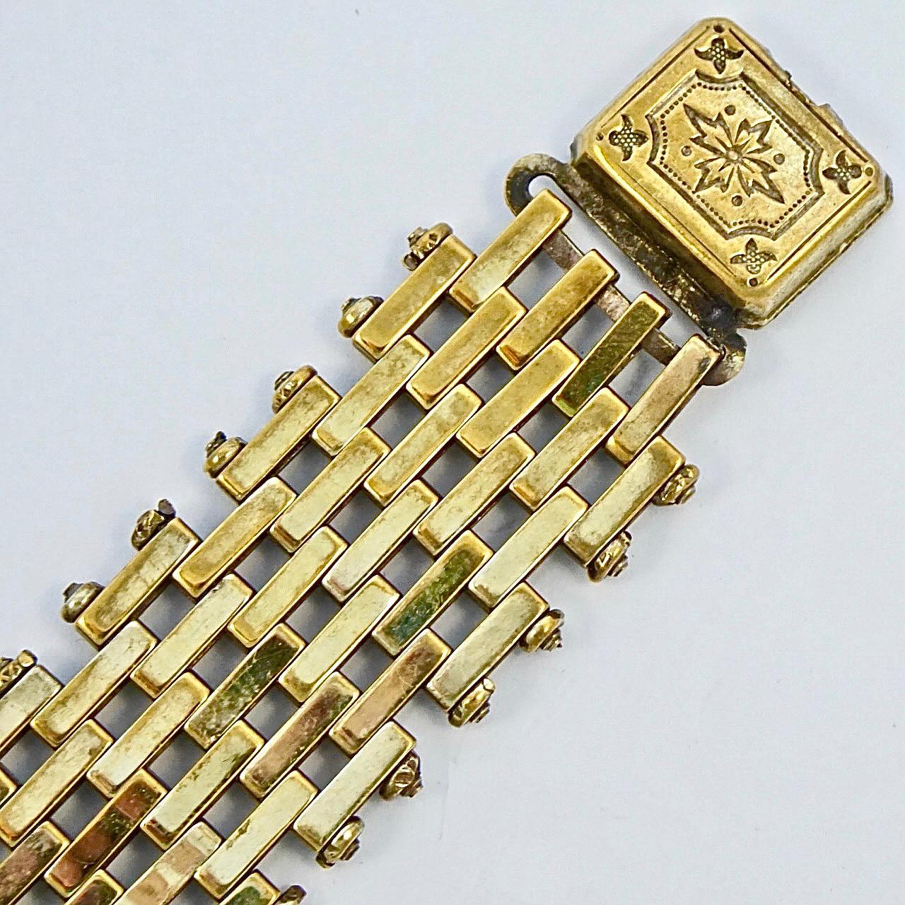 
Wonderful Jakob Bengel Art Deco gold tone bracelet with brickwork links and an ornate clasp. Circa 1930s. Measuring length 17.8 cm / 7 inches by width 1.9 cm / .75 inch. The bracelet is in very good condition, there is some wear to the gold tone