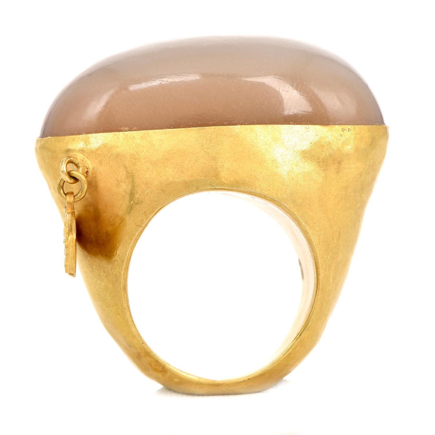  Stand out from the crowd with this attractive piece from the Canadian- Persian Designer Jaleh Farhadpour,

This stunning ring is hand-crafted in 18 karats yellow gold with a satin finish, hosts one Large Cats Eye Cabochon oval stone, measuring
