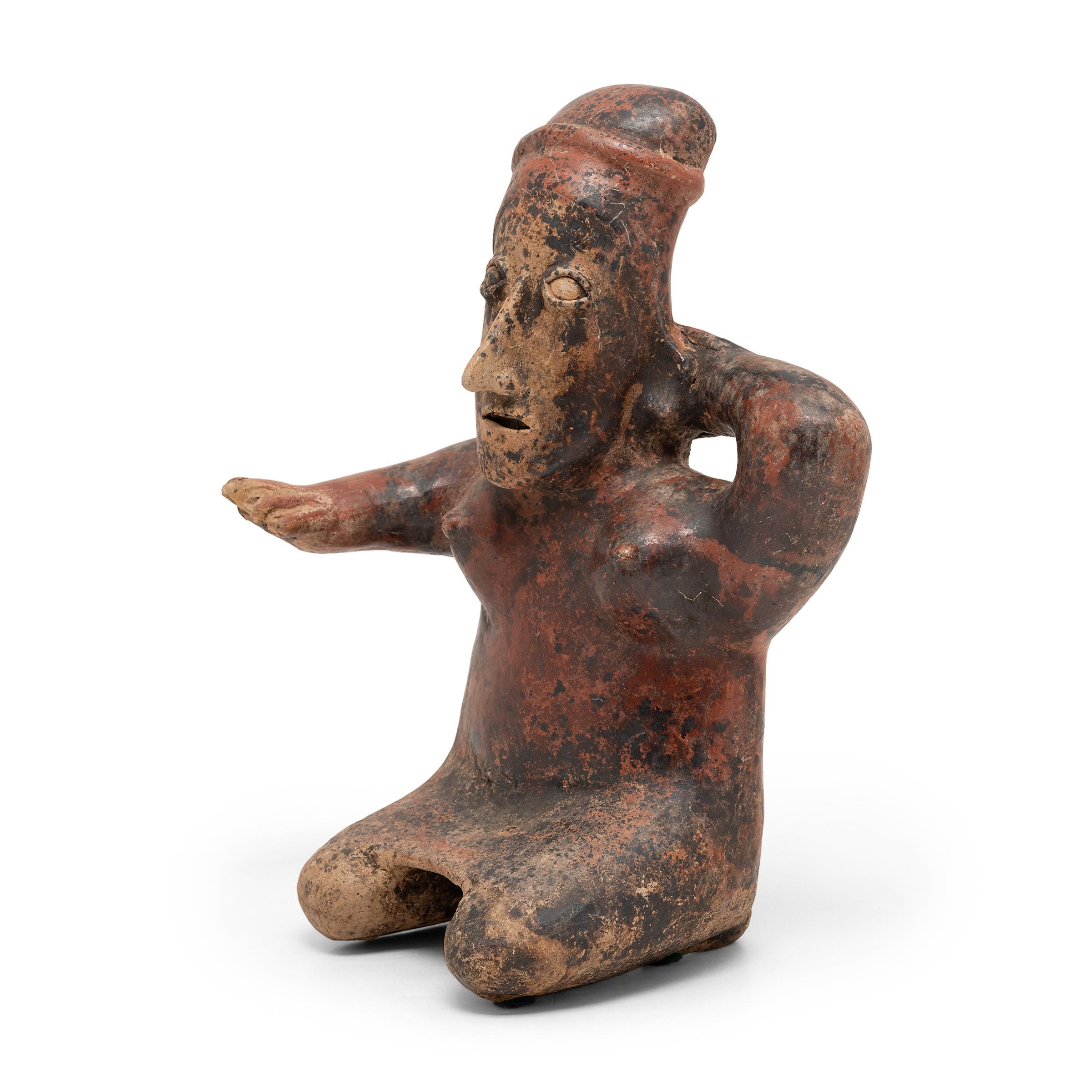 This commanding earthenware figure is attributed to the Jalisco region of Western Mexico and dates to ca. 400 AD. Possibly depicting an ancestor, warrior, or mythical person, the figure was likely one of a group of figures placed within a tomb to