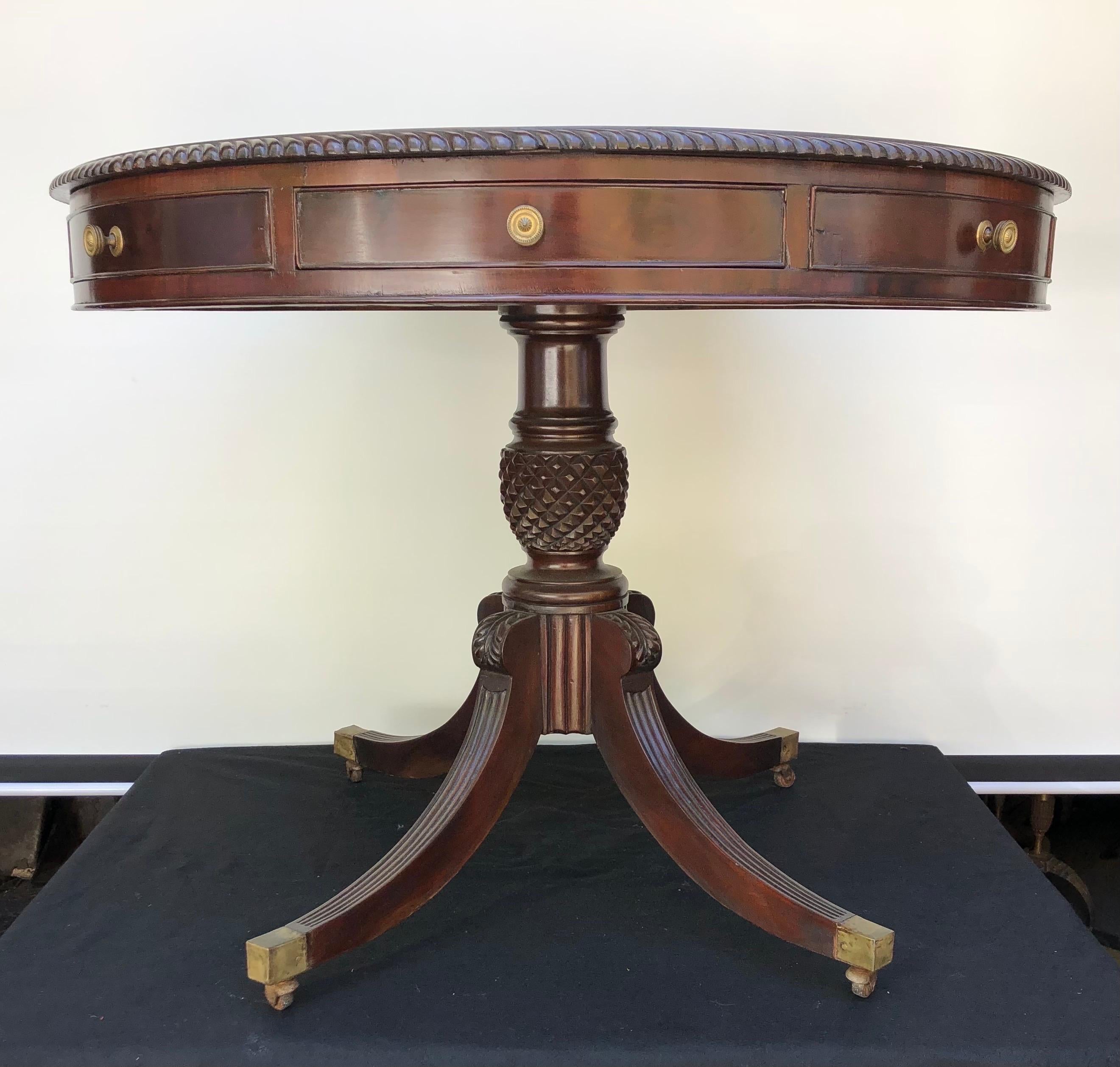 Sophisticated Jamaican Regency pineapple carved pedestal table was hand made in the 19th Century using the finest solid mahogany. The West Indies Table is in the form of a Rent Table with eight drawers (four faux drawers and four working). The top