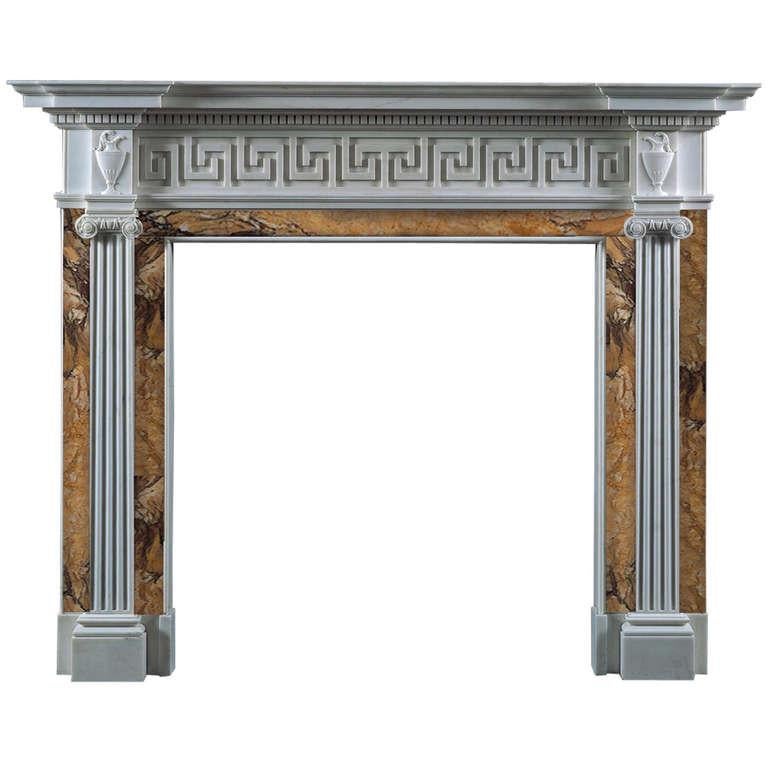 The dramatic classical proportions and finely carved decoration on this chimneypiece include elegantly fluted Roman ionic pilasters. The key fret carved frieze and the classical urns beneath the dentil molding on each side reinforce the art of