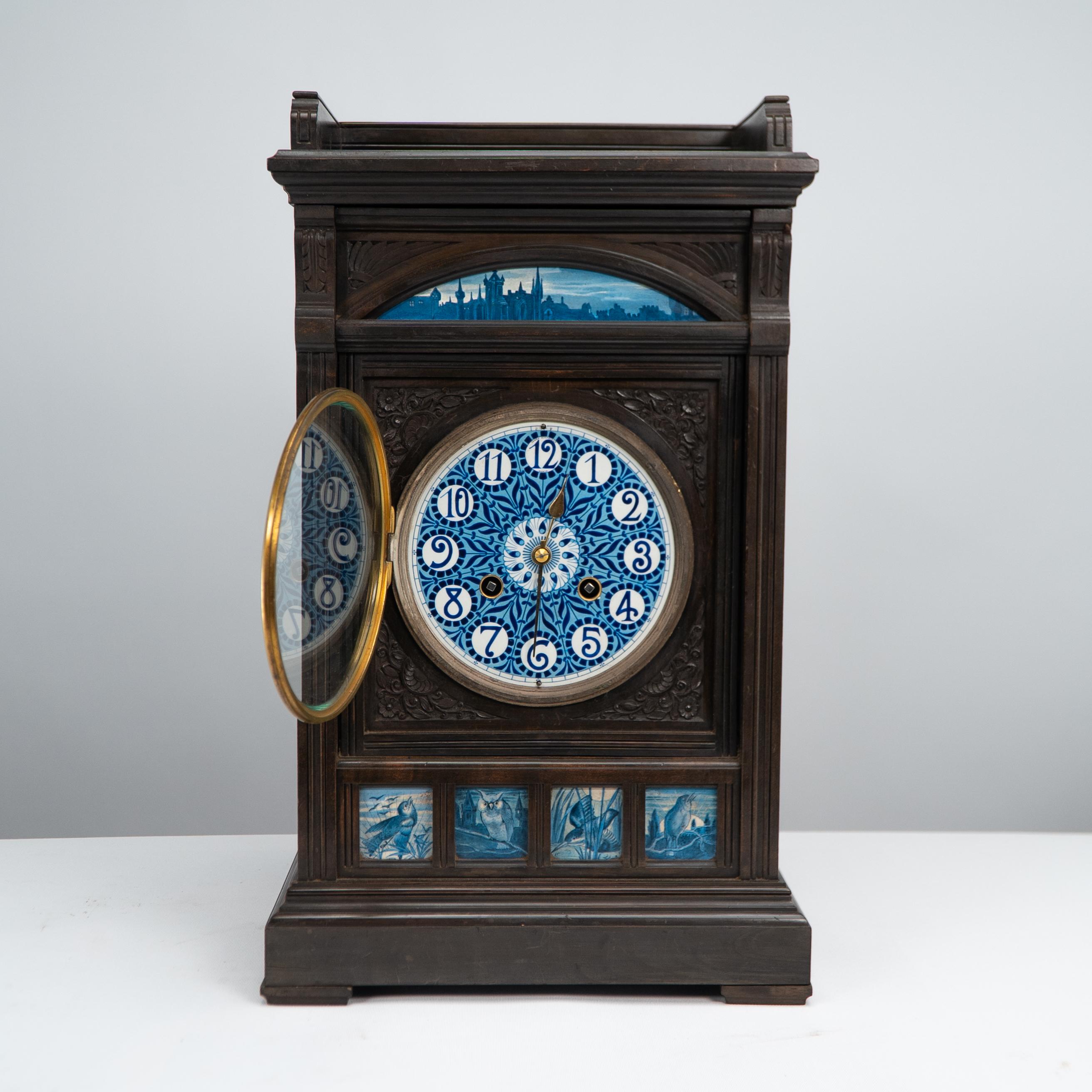 An Aesthetic Movement mantel or bracket clock, Signed James Aitchison, Paris in the number 12, with finely carved floral decoration to the front and sides, a french city evening scene depicting knockturn with handpainted stylised floral sunflowers
