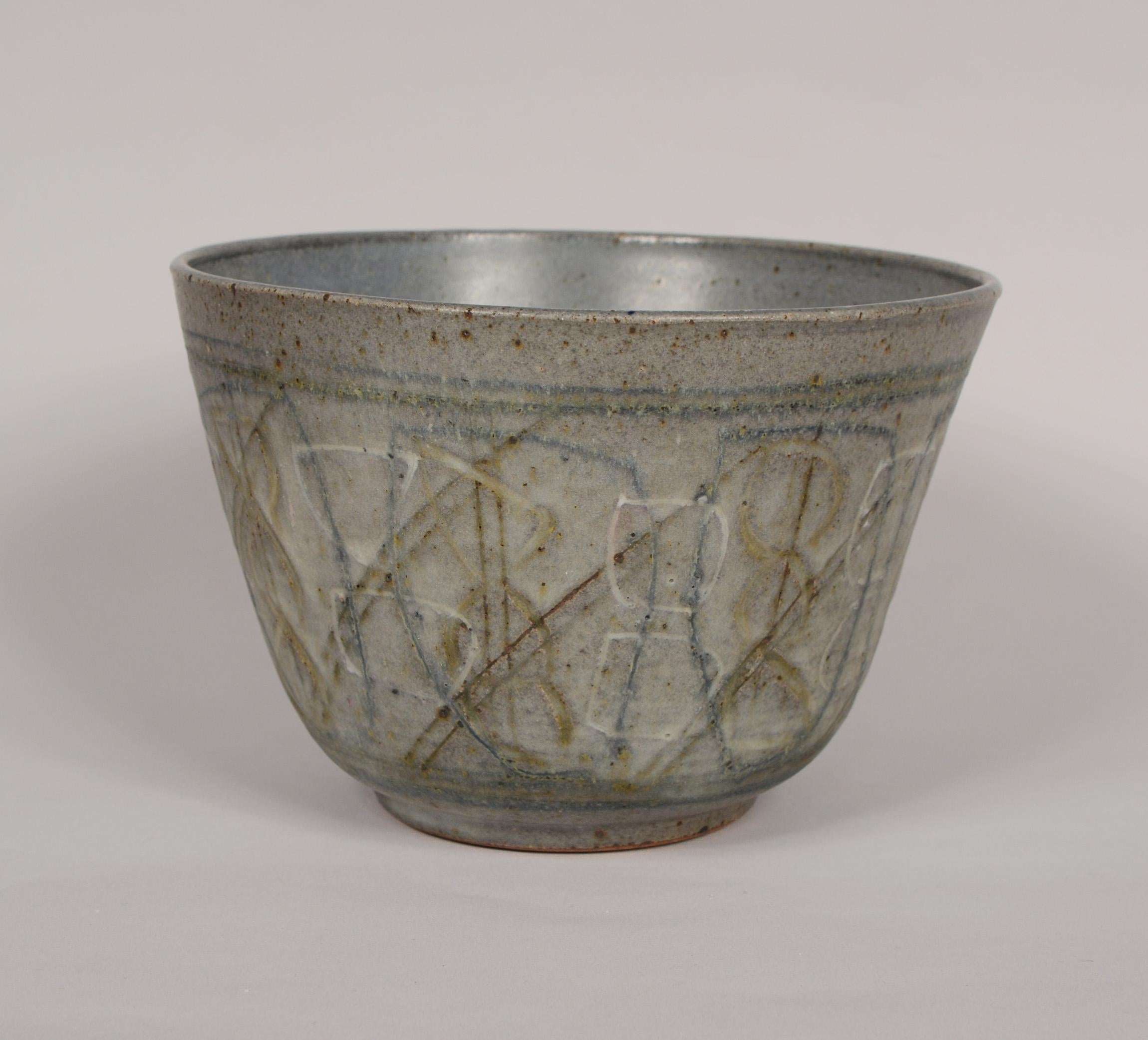 Ceramic bowl with an abstract sgraffito decoration by James and Nan McKinnell.

Jim and Nan studied ceramics at the University of Washington. Jim and Nan moved to Colorado in 1951, where they both taught pottery classes at the University of