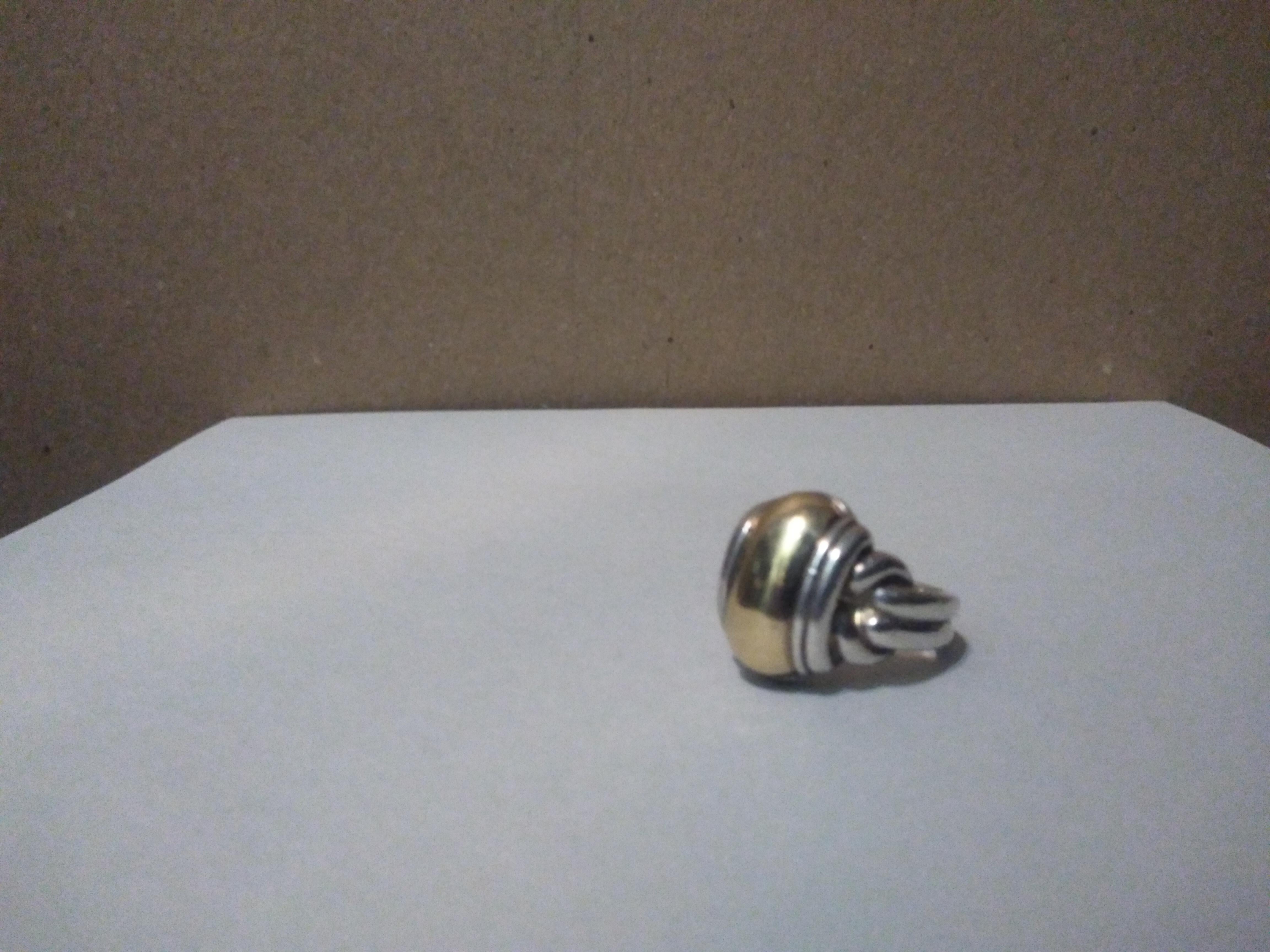 This is a James Avery Sterling Silver and 14k Gold dome style ring. It has a double band.