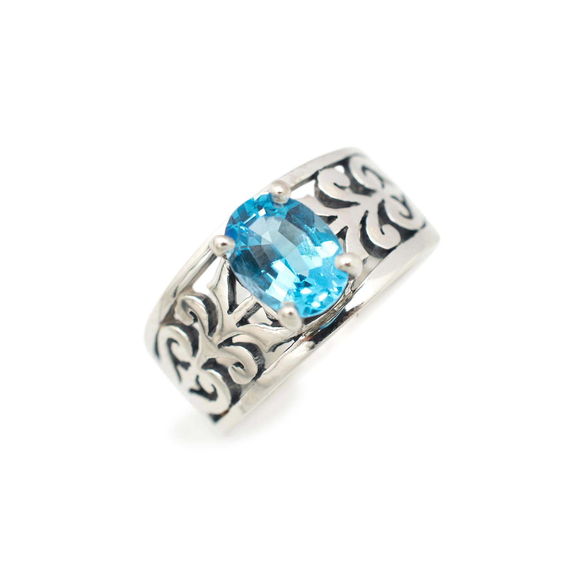Gender: Ladies

Metal Type: 925 Sterling Silver

Size: 6.5

Shank Maximum Width: 9.65 mm

Weight: 4.90 grams

Ladies 925 sterling silver blue topaz cocktail ring with a tapered shank. Engraved with 