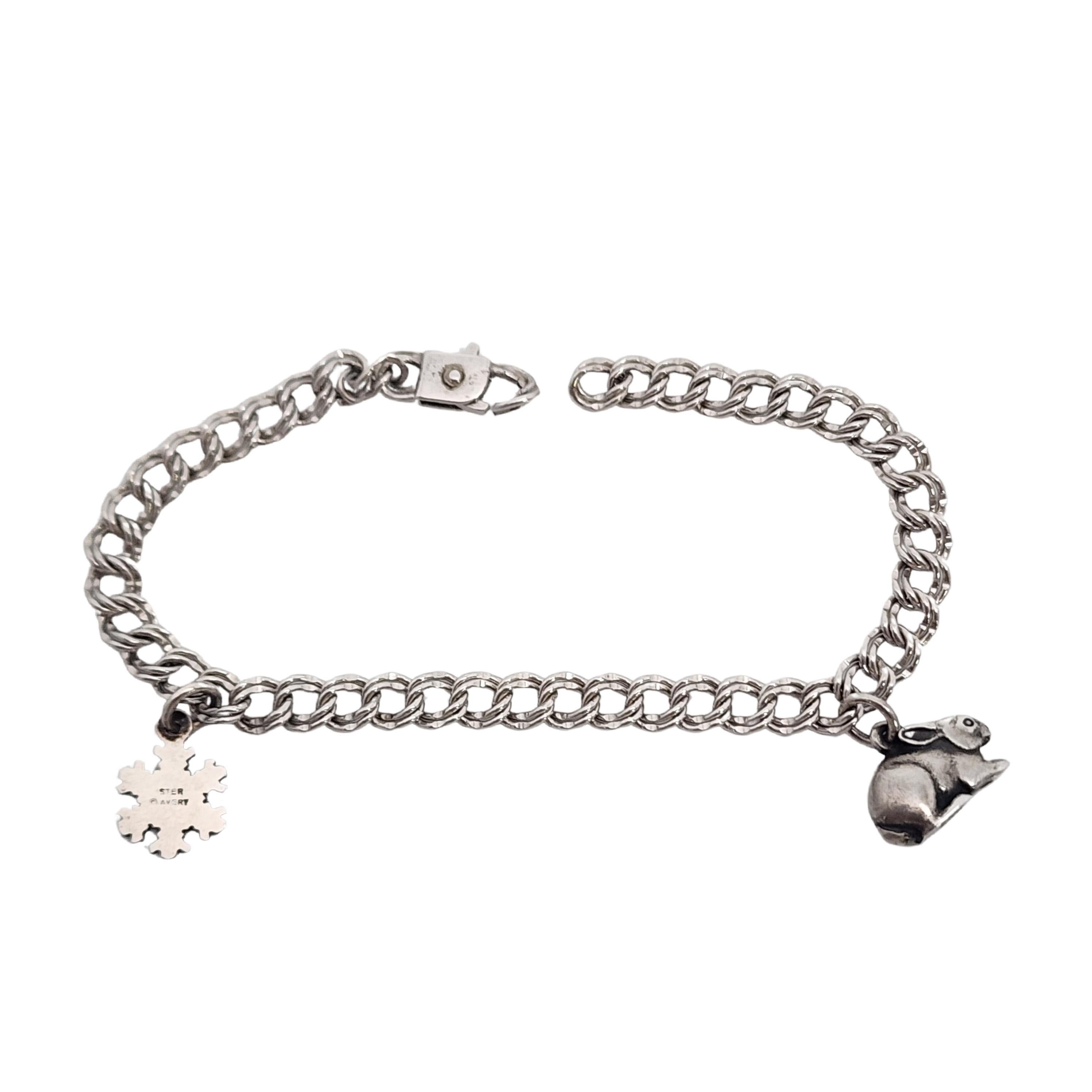 Sterling silver charm bracelet with rabbit and snowflake charms by James Avery.

Double round link bracelet with James Avery's Cottontail bunny rabbit charm and Aspen Crystal snowflake charms.

Bracelet measures approx 7
