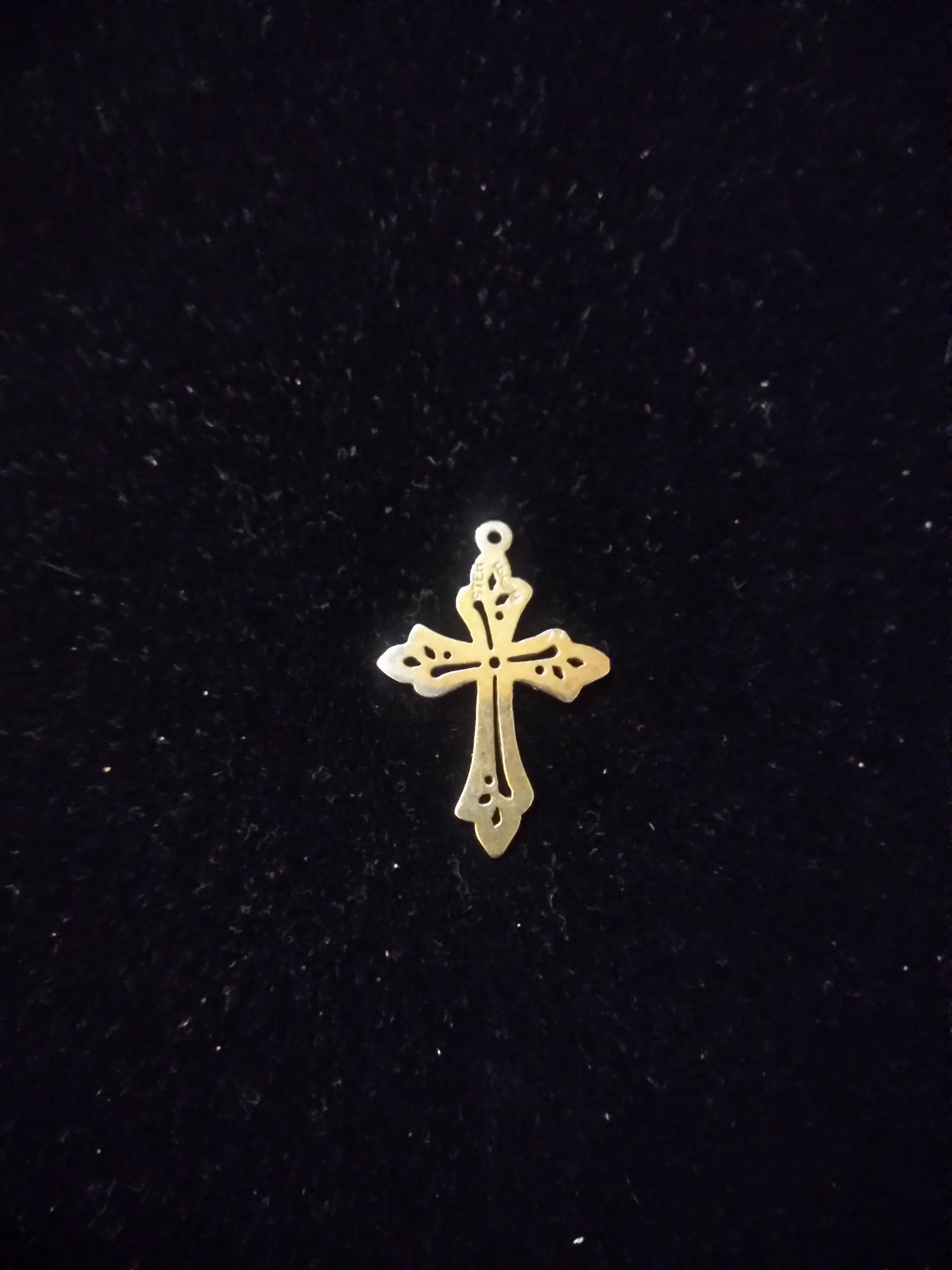 This is a sterling silver cross pendant hand crafted by James Avery Jewelers.