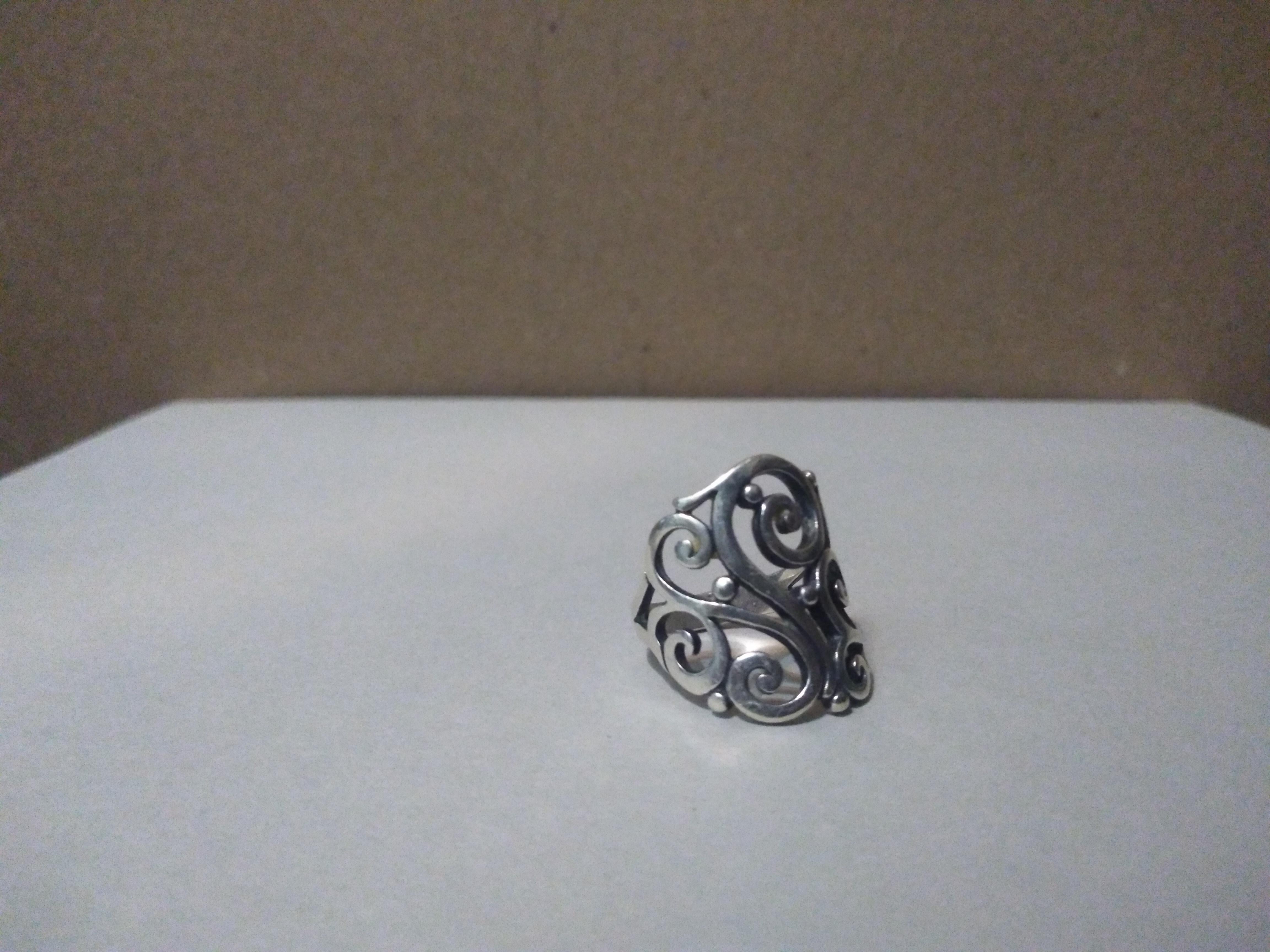 This is a stunning James Avery creation. This ring is made of sterling silver and and has intricate filligree. 