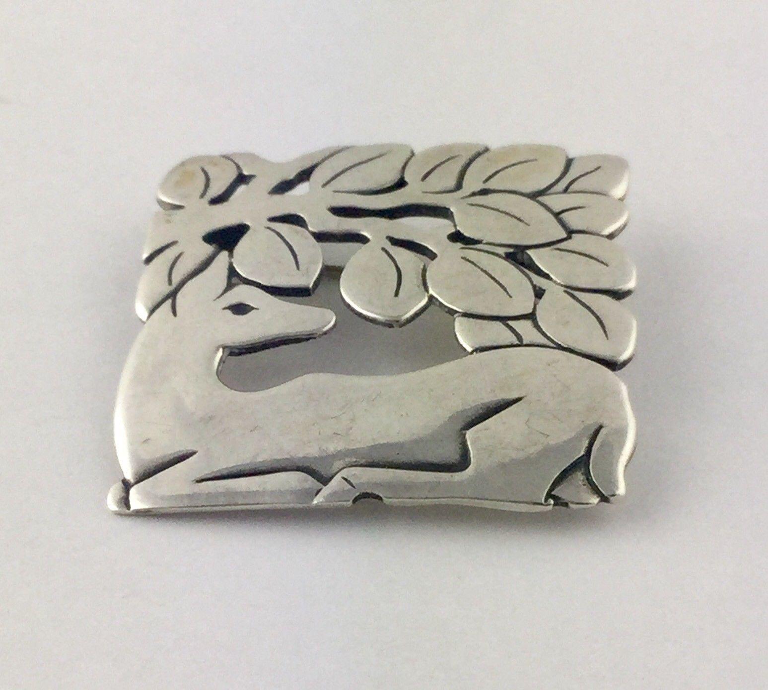 James Avery New Deer under a tree pin brooch.

Marked: JA with candelabra STER

Measures: 1 1/8