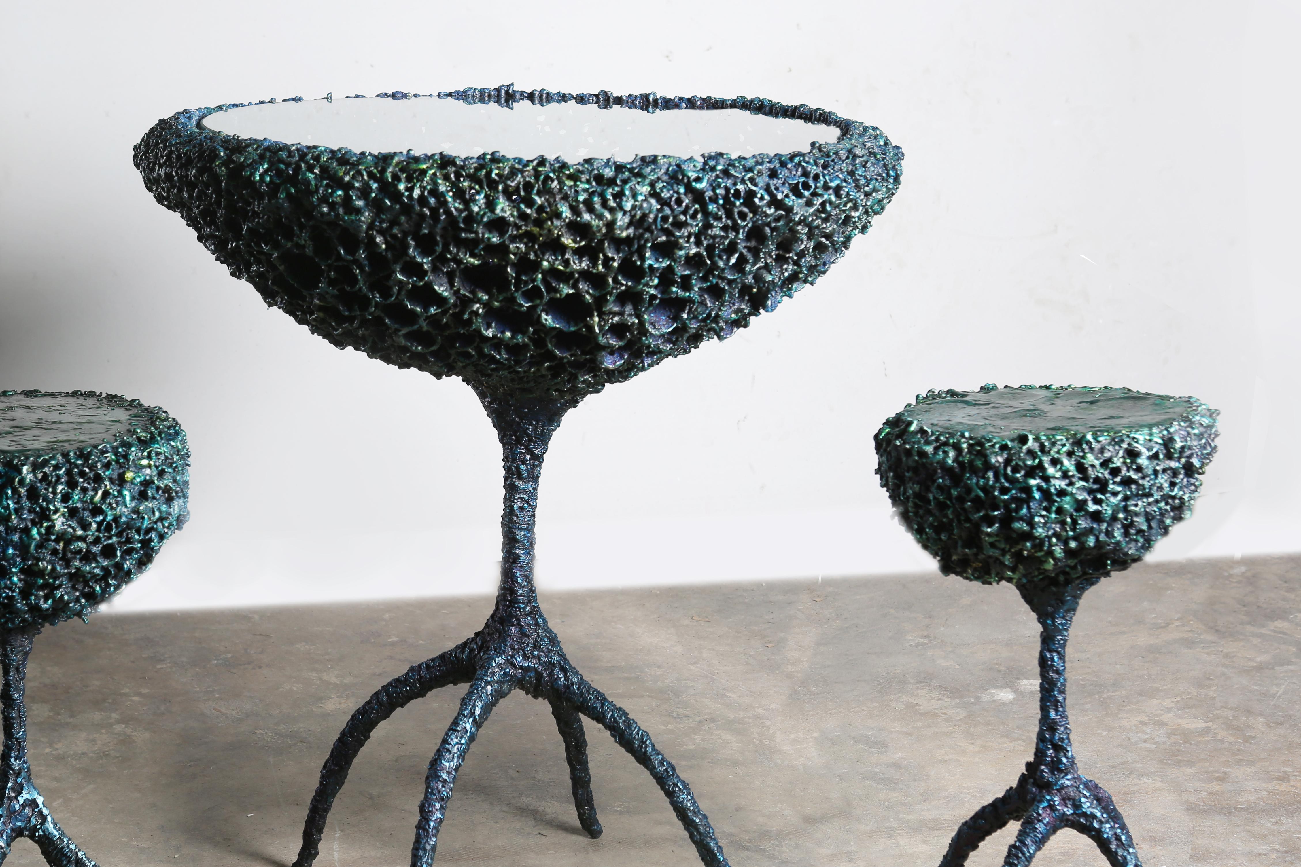 Elysium series round table on sinuous, biomorphic legs with two matching stools of torch-cut and patinated steel, dyed bronze, and clear coat. By American artist James Bearden. The textured exterior of the set and the relatively smooth top of the