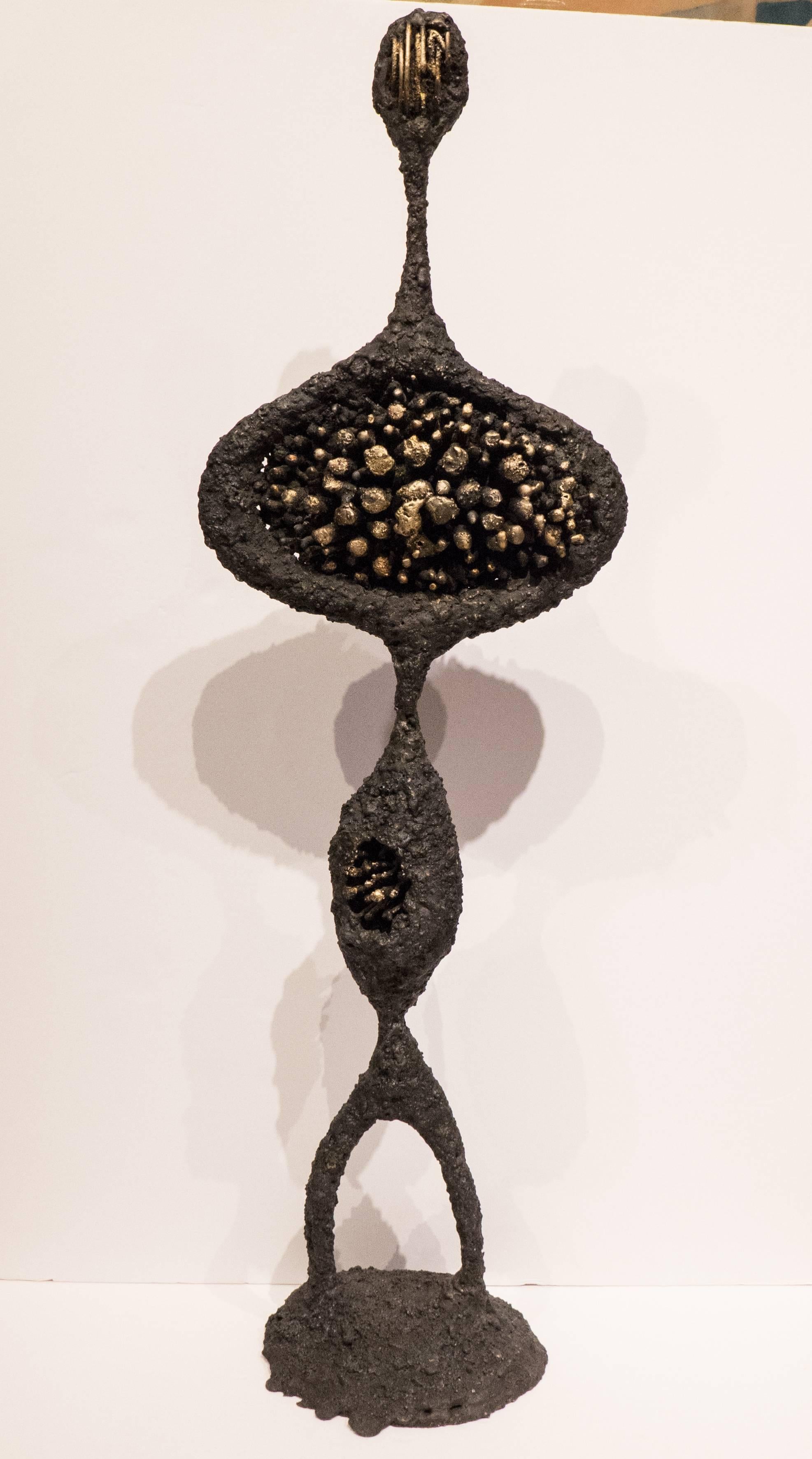 Brutalist figural sculpture of blackened steel and fused bronze, titled 